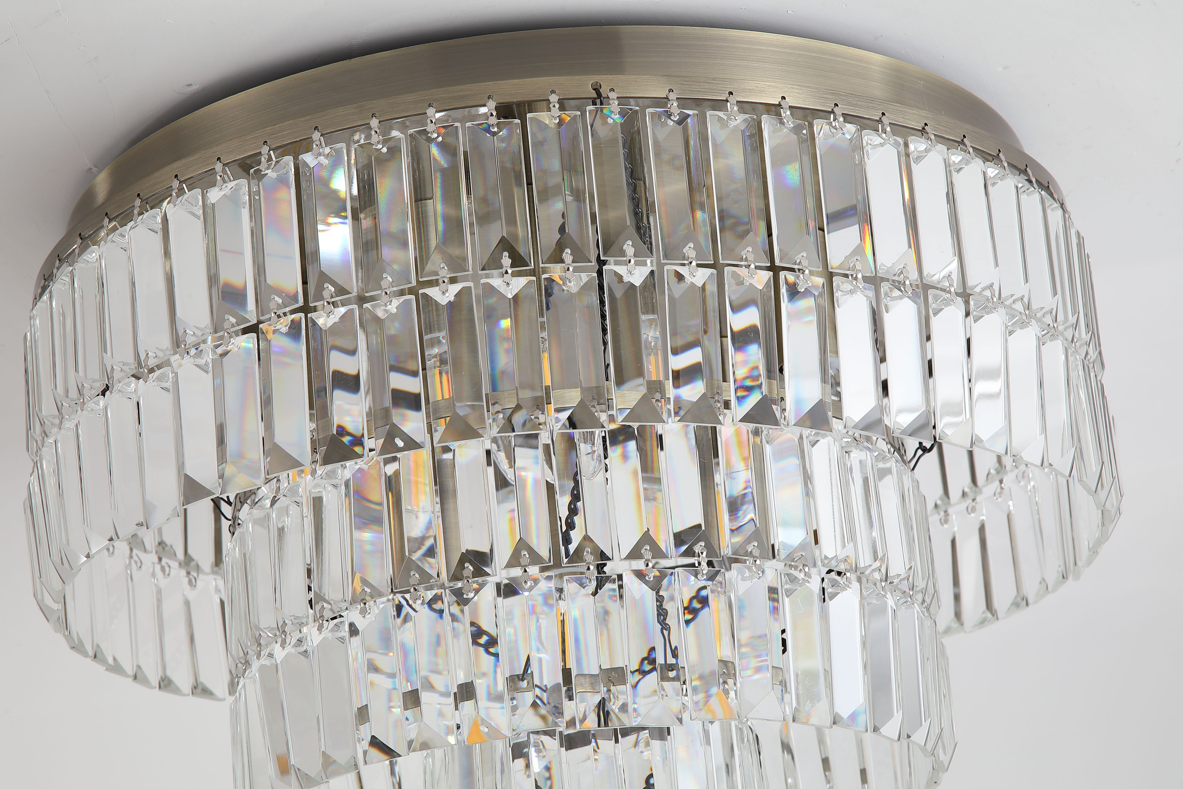 Close up of the crystal tiers and brass fixings on the Empire 6 Light Flush
