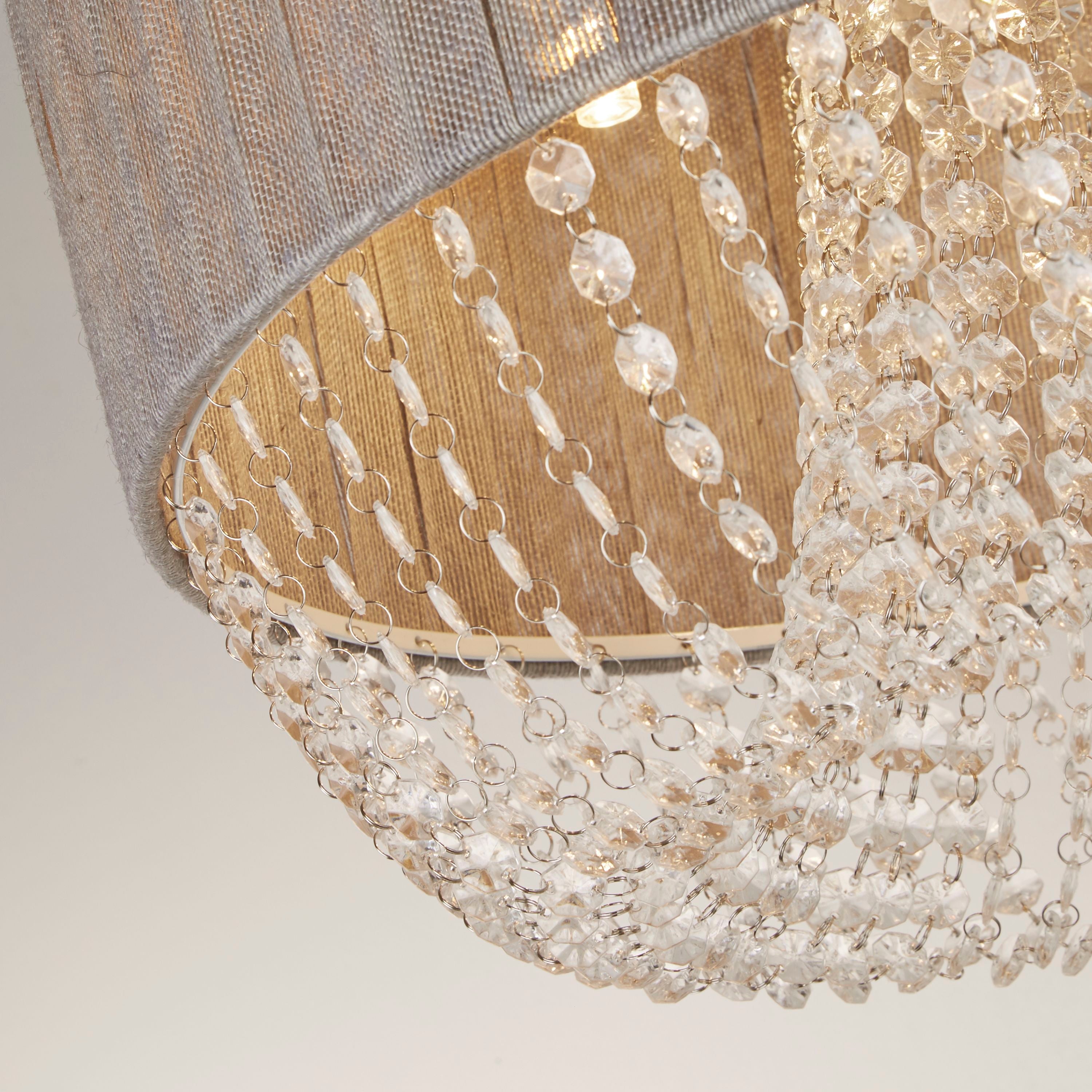 Close up of the Searchlight Bellano 5 light, showing the grey pleated fabric shade, chrome trim and faceted clear acrylic droplets