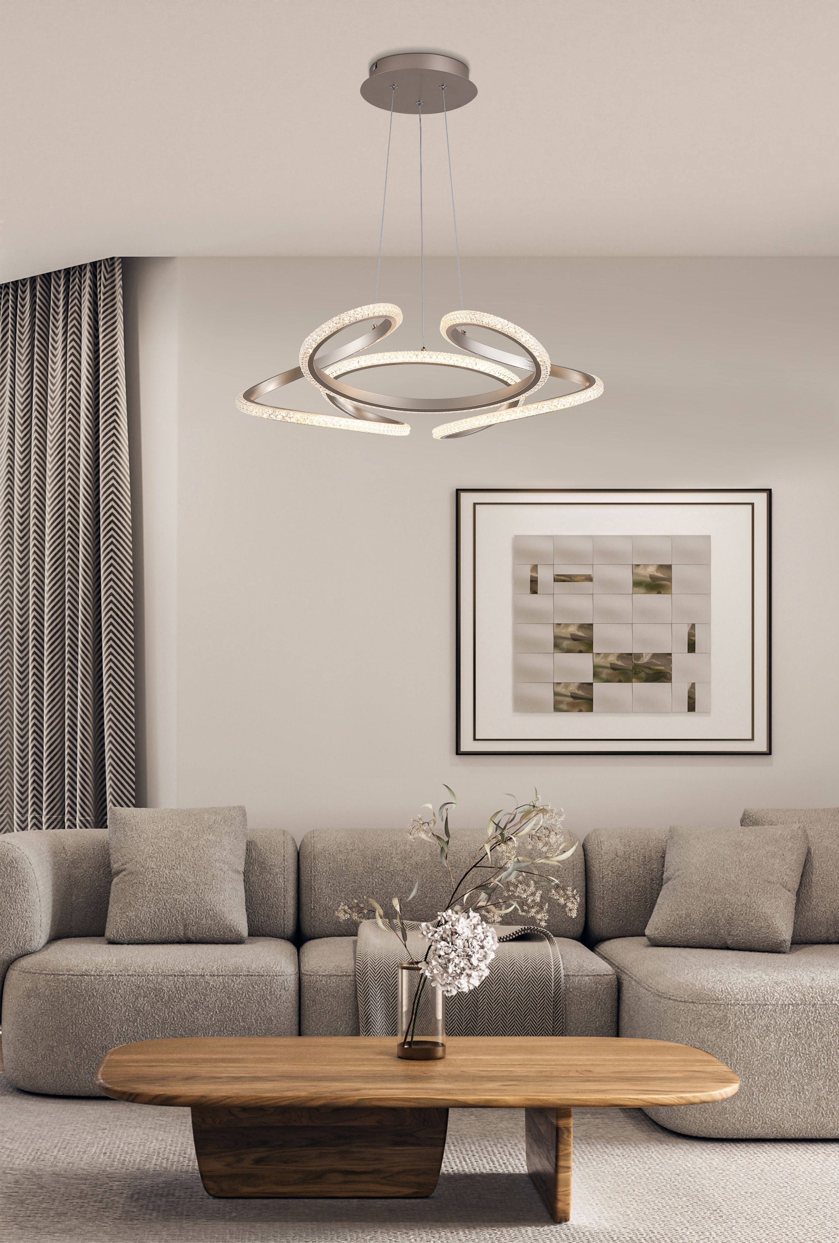 Doodle LED Pendant in champagne styled above a grey sofa and framed abstract art in a modern living room