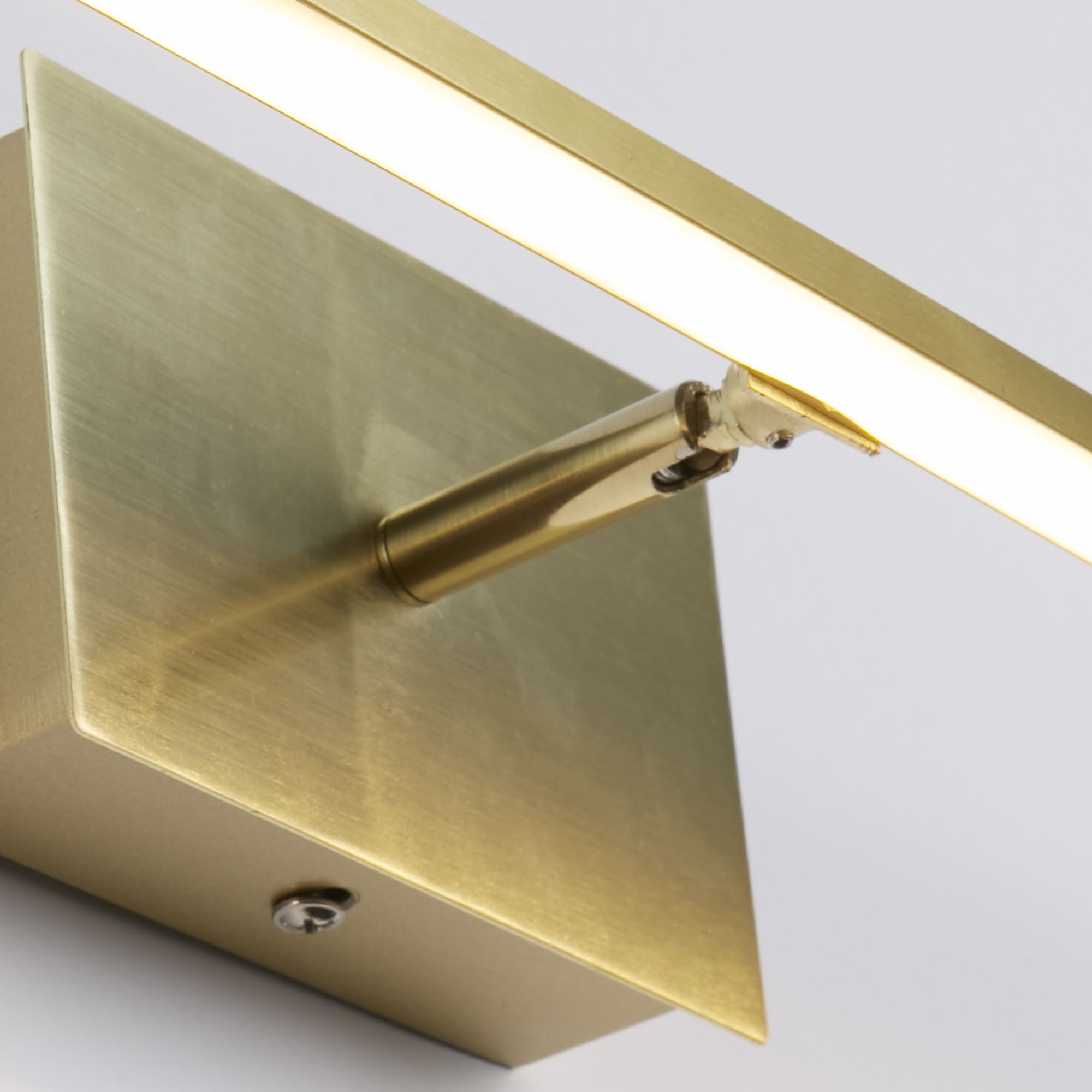 Close up of the satin brass 61cm Amalfi wall light showing the swivel spotlight beneath the bar and the brushed metal backplate