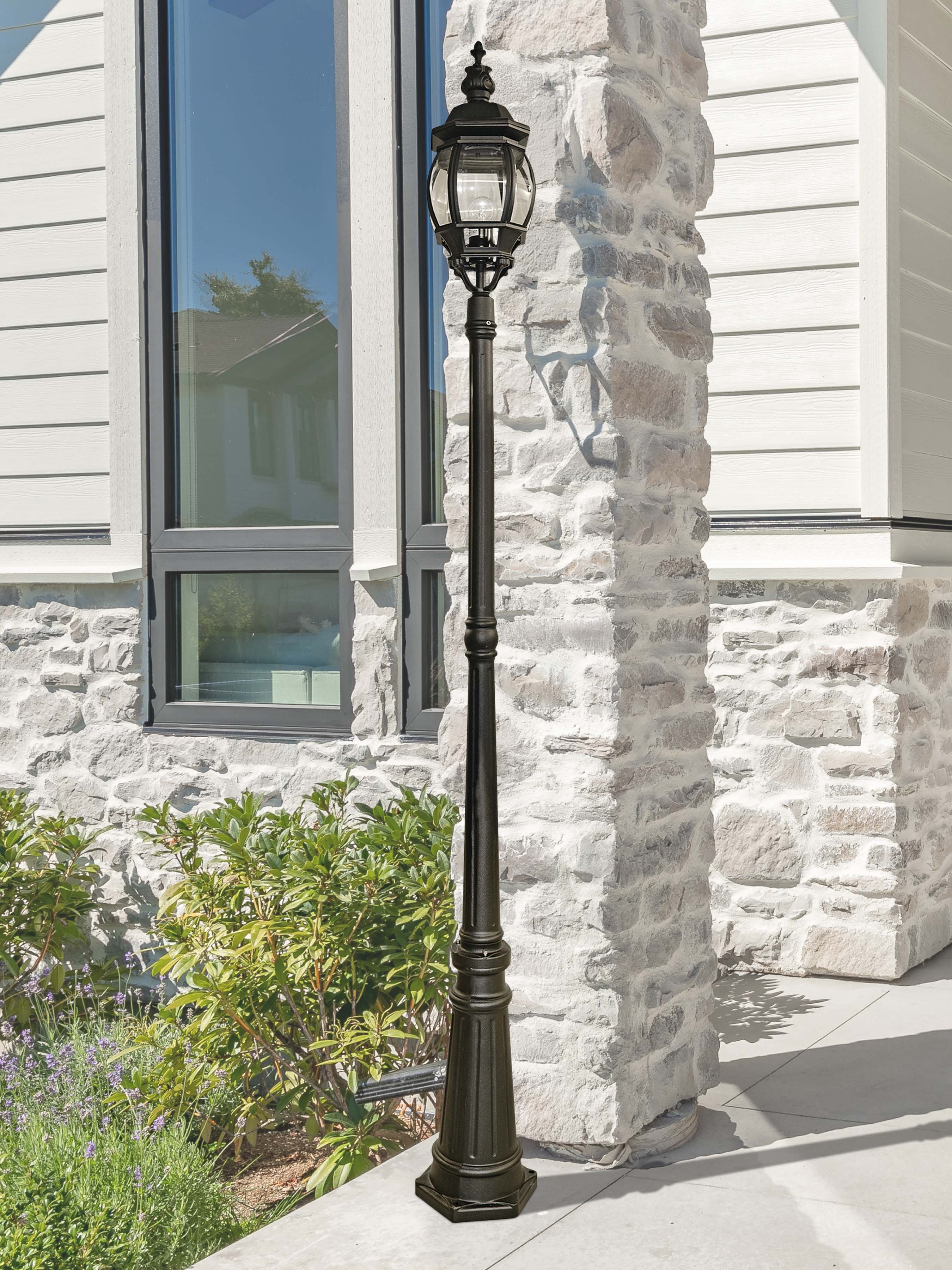 Bel Aire 221cm Outdoor Post lit at dusk beside a stone pillar, with lavender planting in the foreground