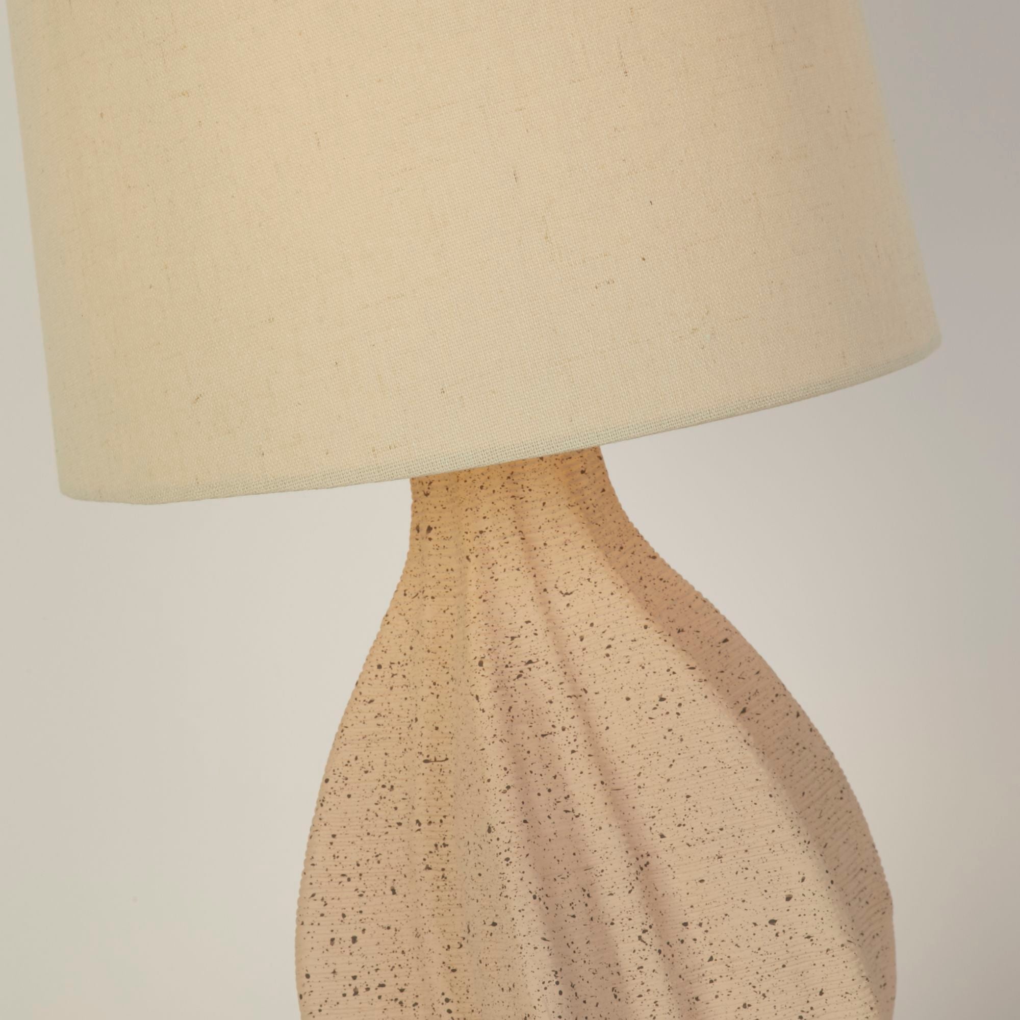 Close up of the Twist table lamp base showing the speckled ceramic finish and twisted, wrapped fold texture