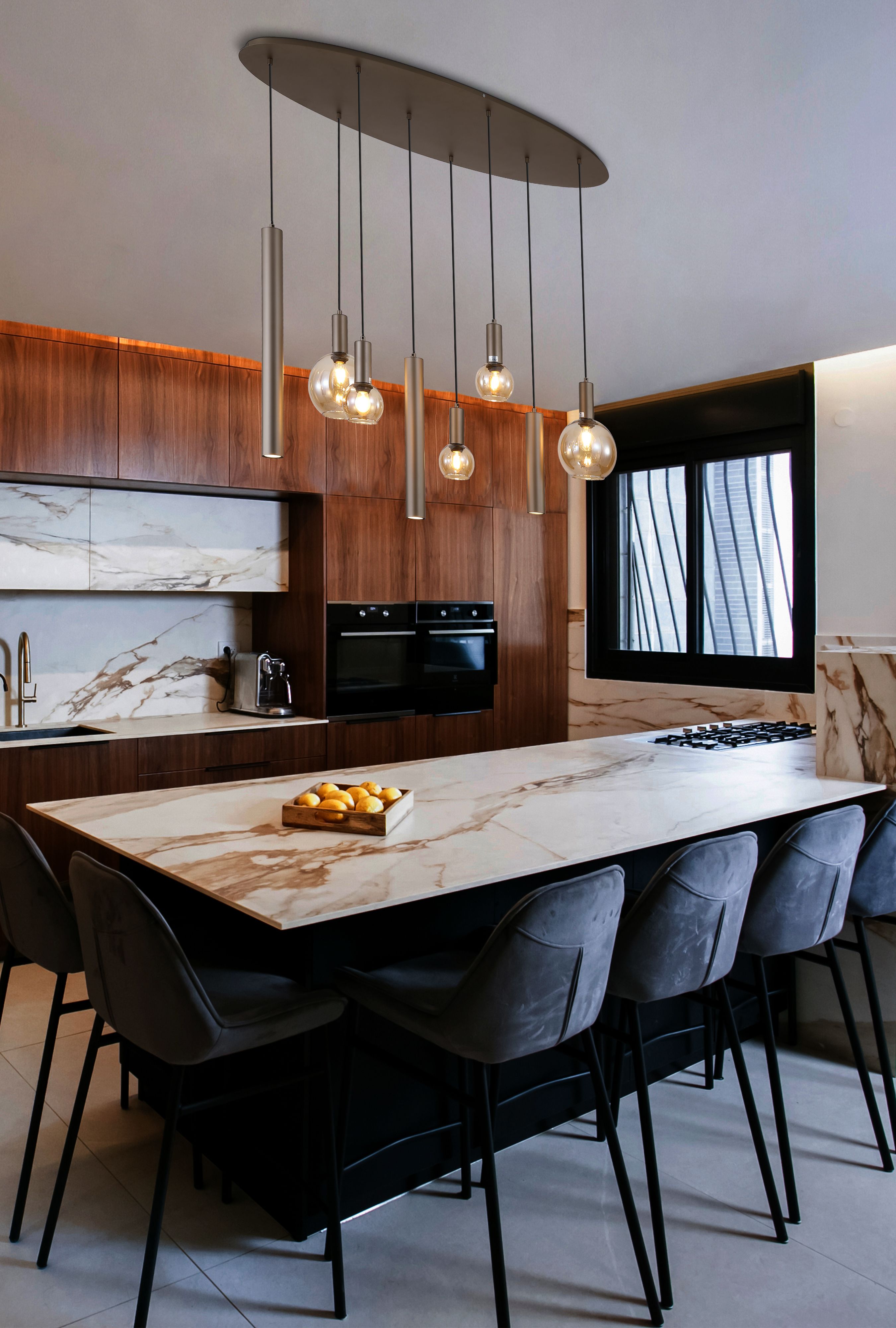 Searchlight Lyon 8 light pendant in latte metal and amber glass hanging above a marble kitchen island with bar stools