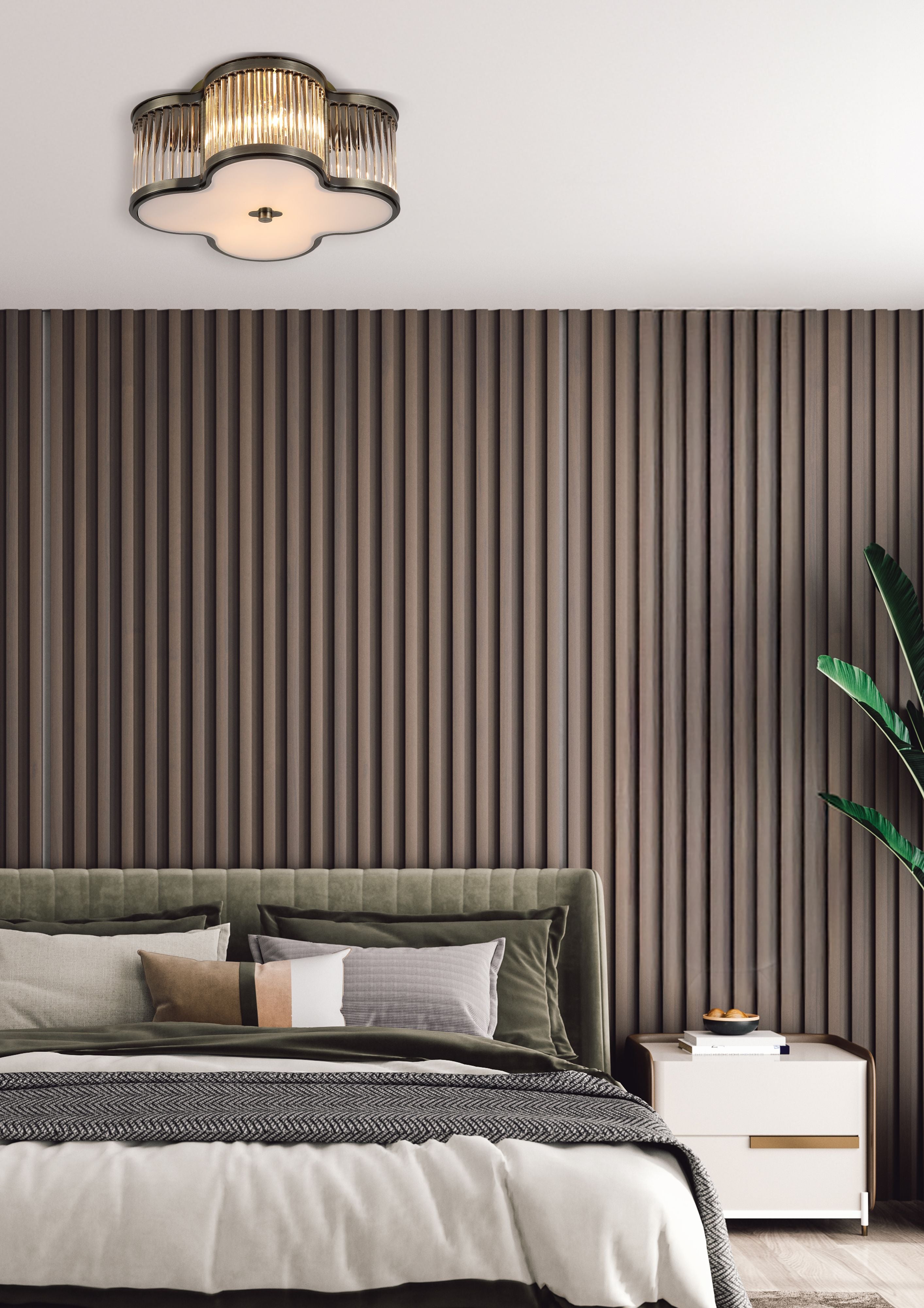 Searchlight Lotus 2 light flush ceiling light in antique brass installed above a bed in a bedroom with a wood slat feature wall