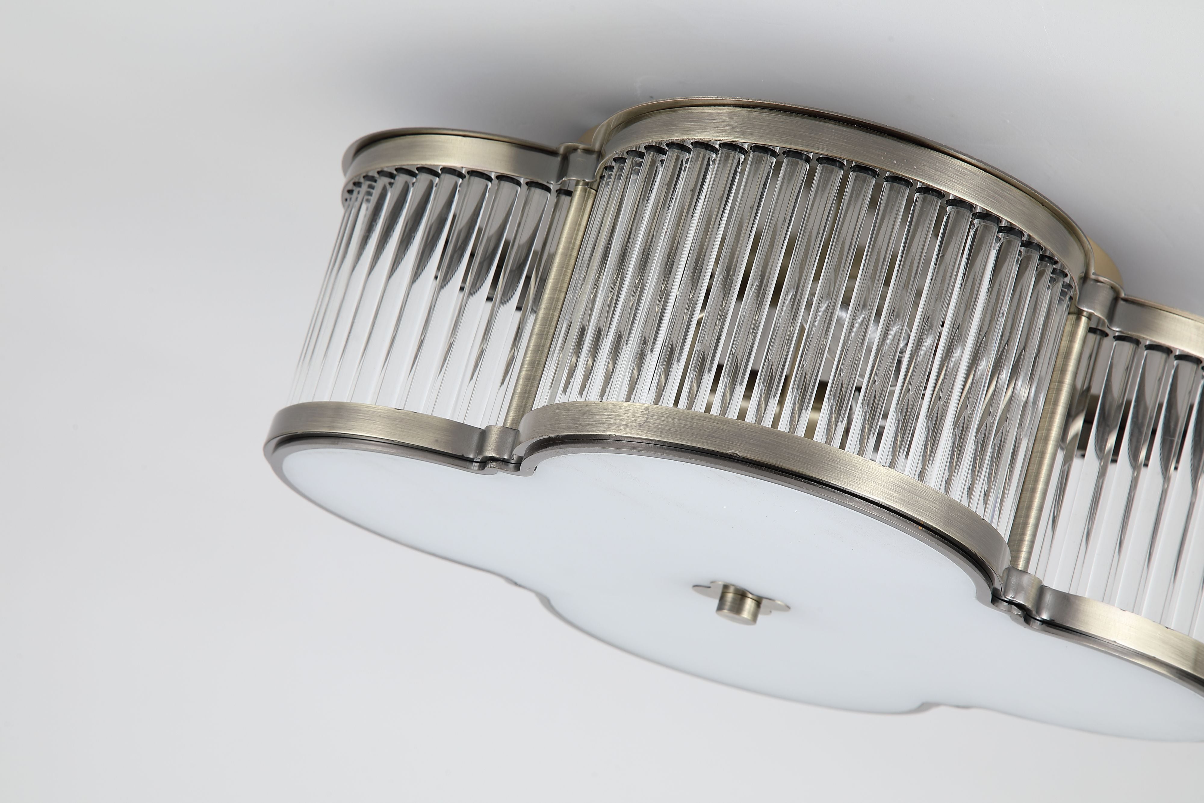 Close up of the ribbed glass rods and antique brass trim on the Searchlight Lotus 3 light flush ceiling light