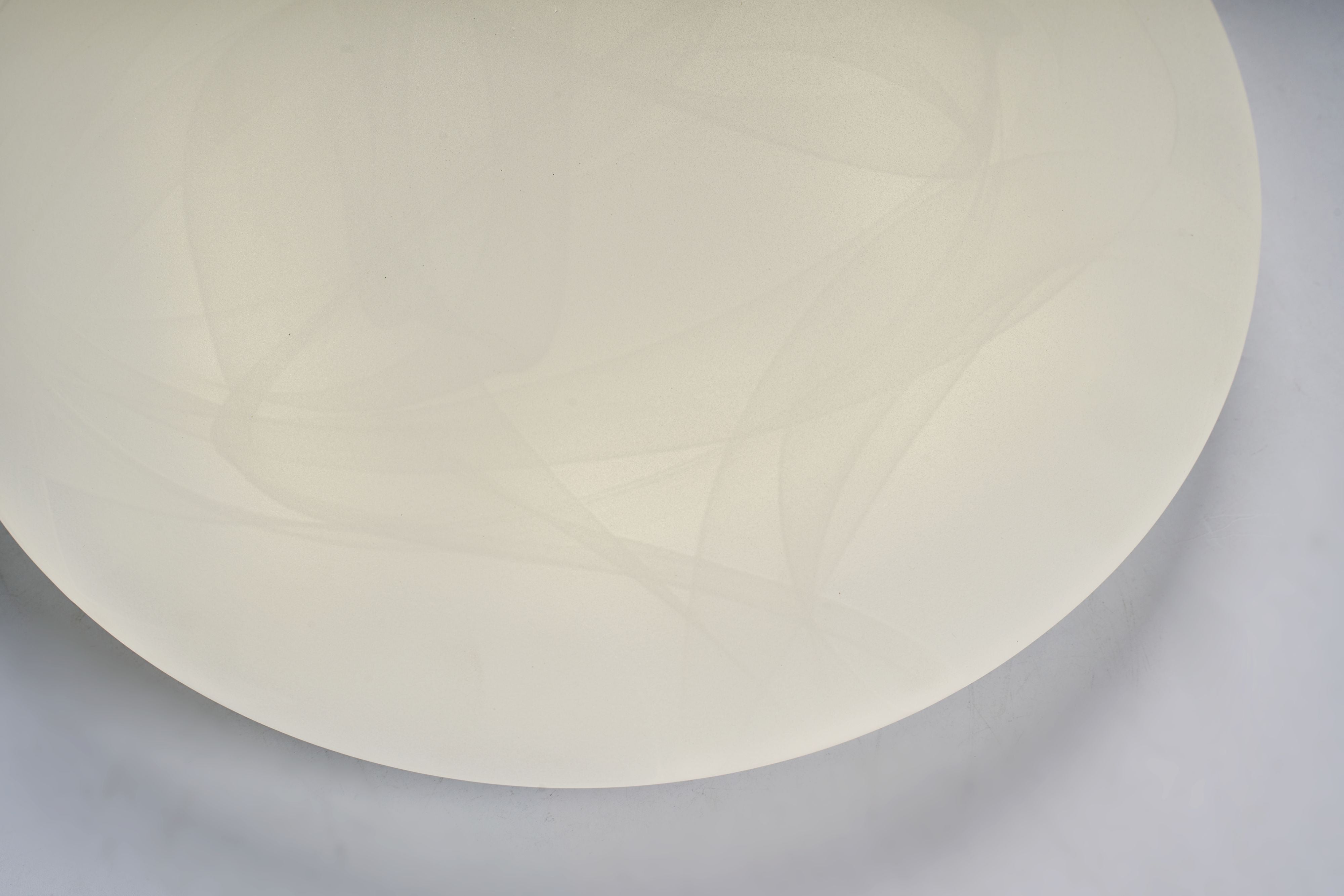 Close up of the white acrylic dome on the Searchlight Maya LED flush light showing the soft marbled swirl pattern