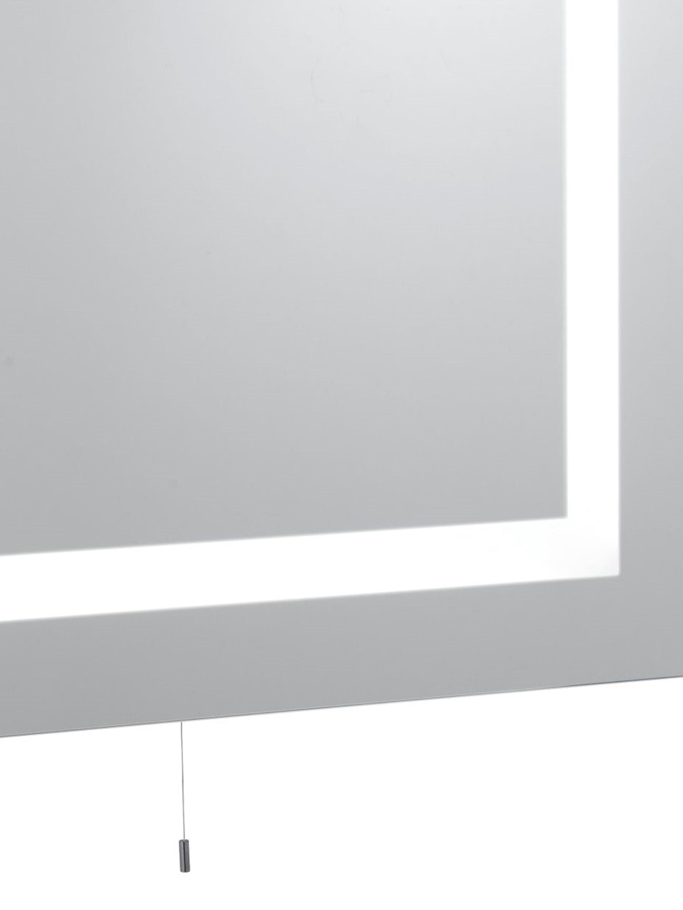 Close up of the corner of the Searchlight rectangular mirror, showing the lit frosted border and the pull cord switch beneath the glass