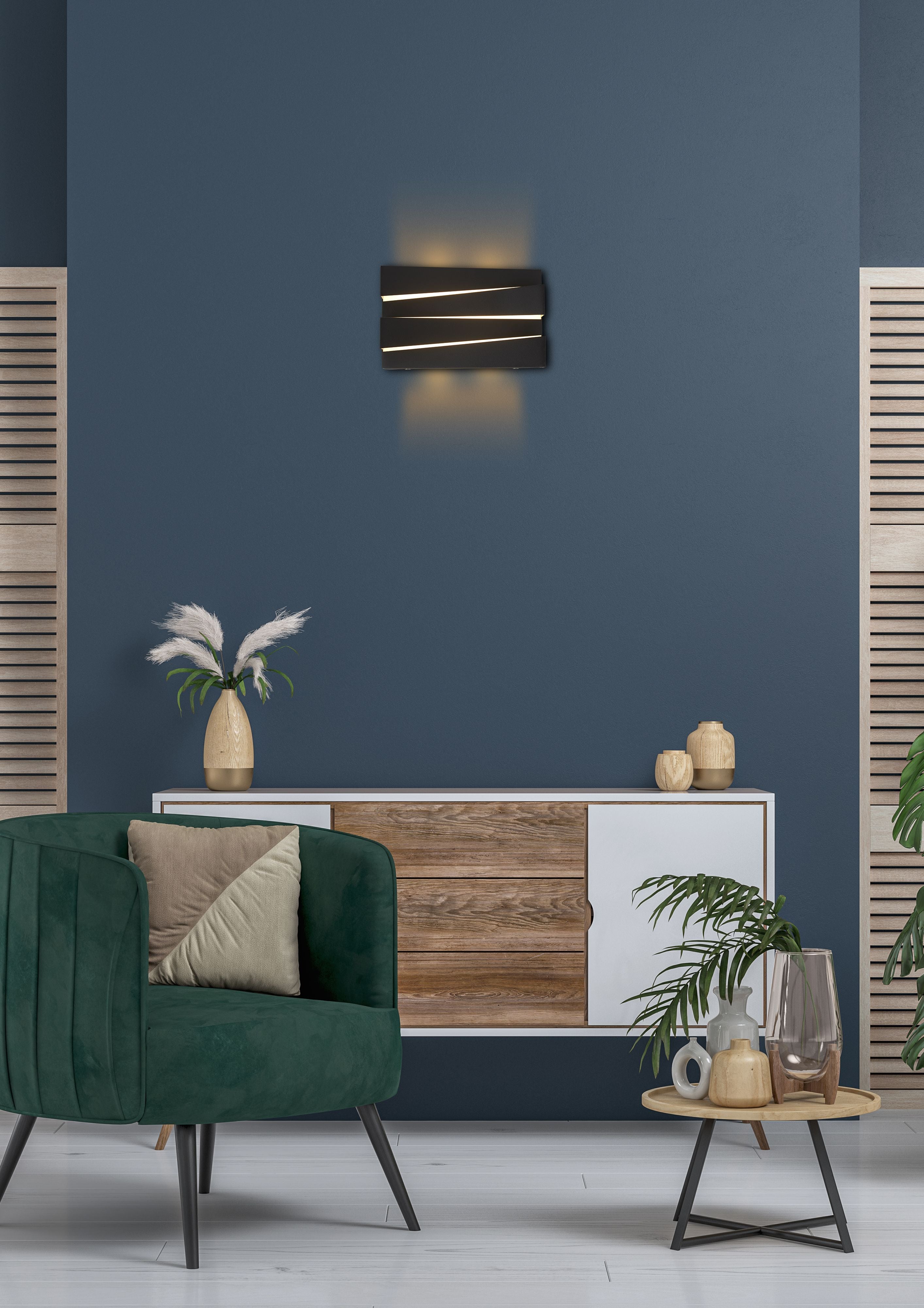 Dark blue feature wall with a wooden and white sideboard, showing the Section wall light in sand black lit and mounted above