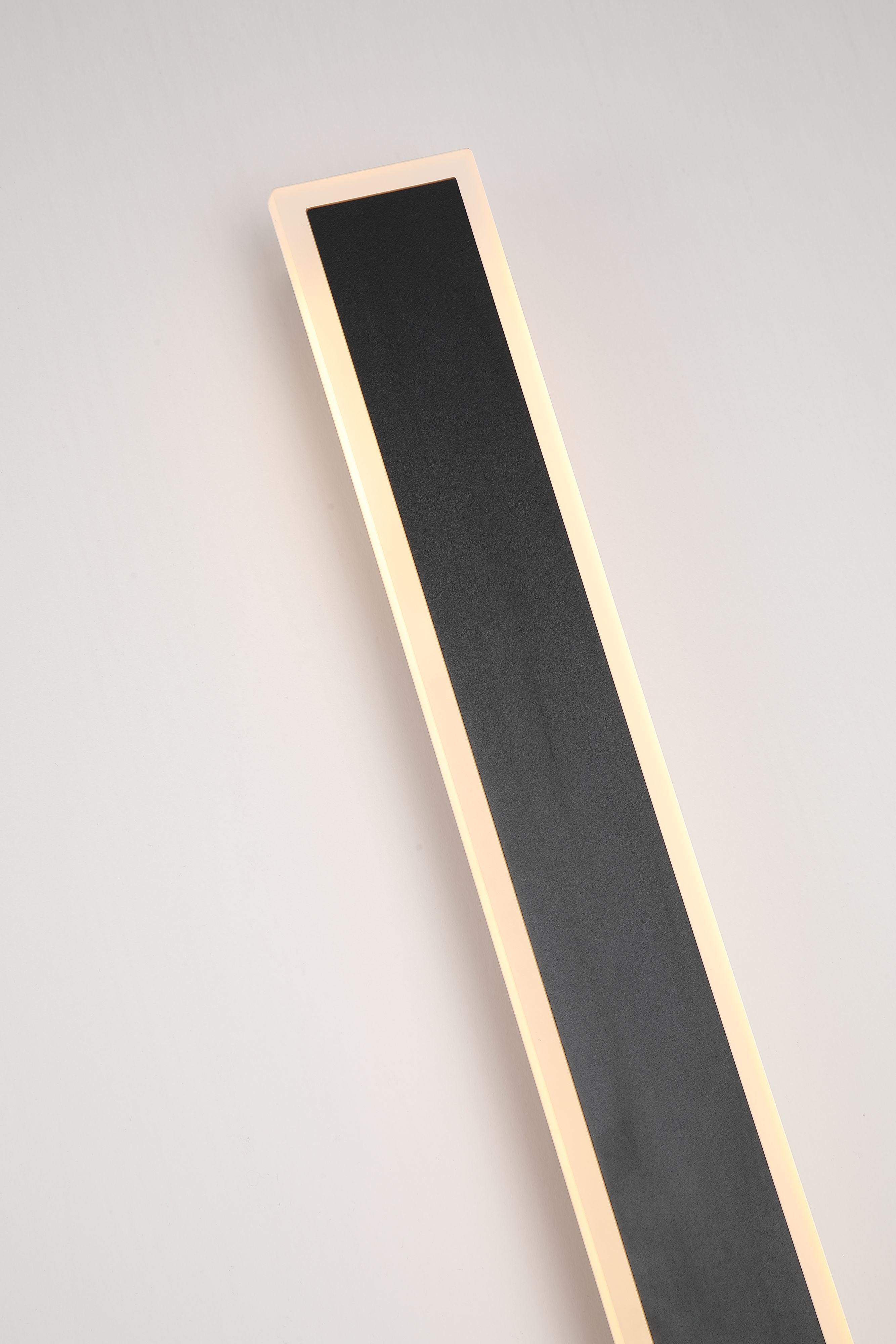 Close up of the sand black textured finish and glowing acrylic edge on the Searchlight Bordo II Square LED Outdoor Wall Light, 1200mm