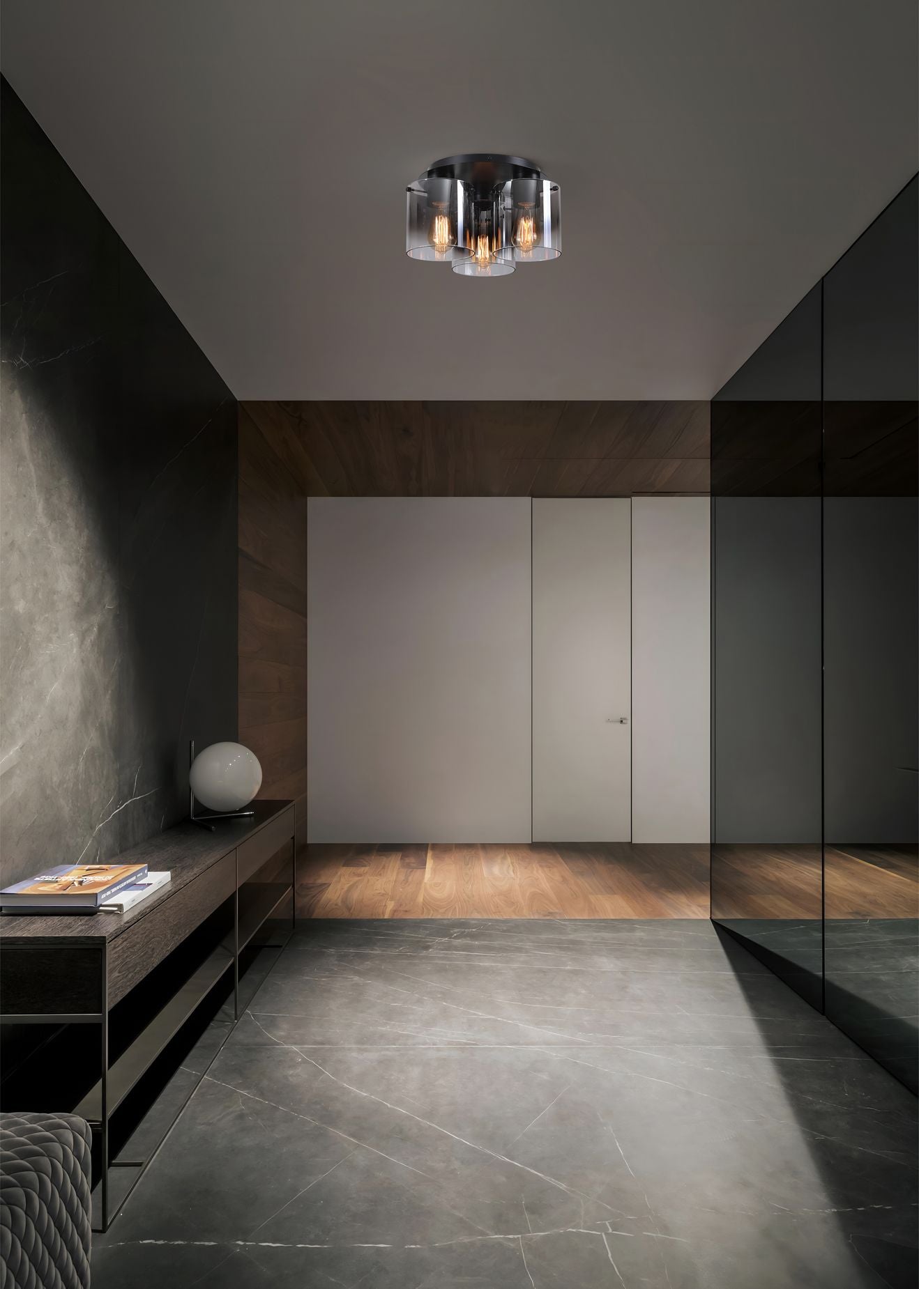 Searchlight Sweden 3 Light Flush in matt black with smoked glass, styled in a dark hallway with a wood sideboard and table lamp