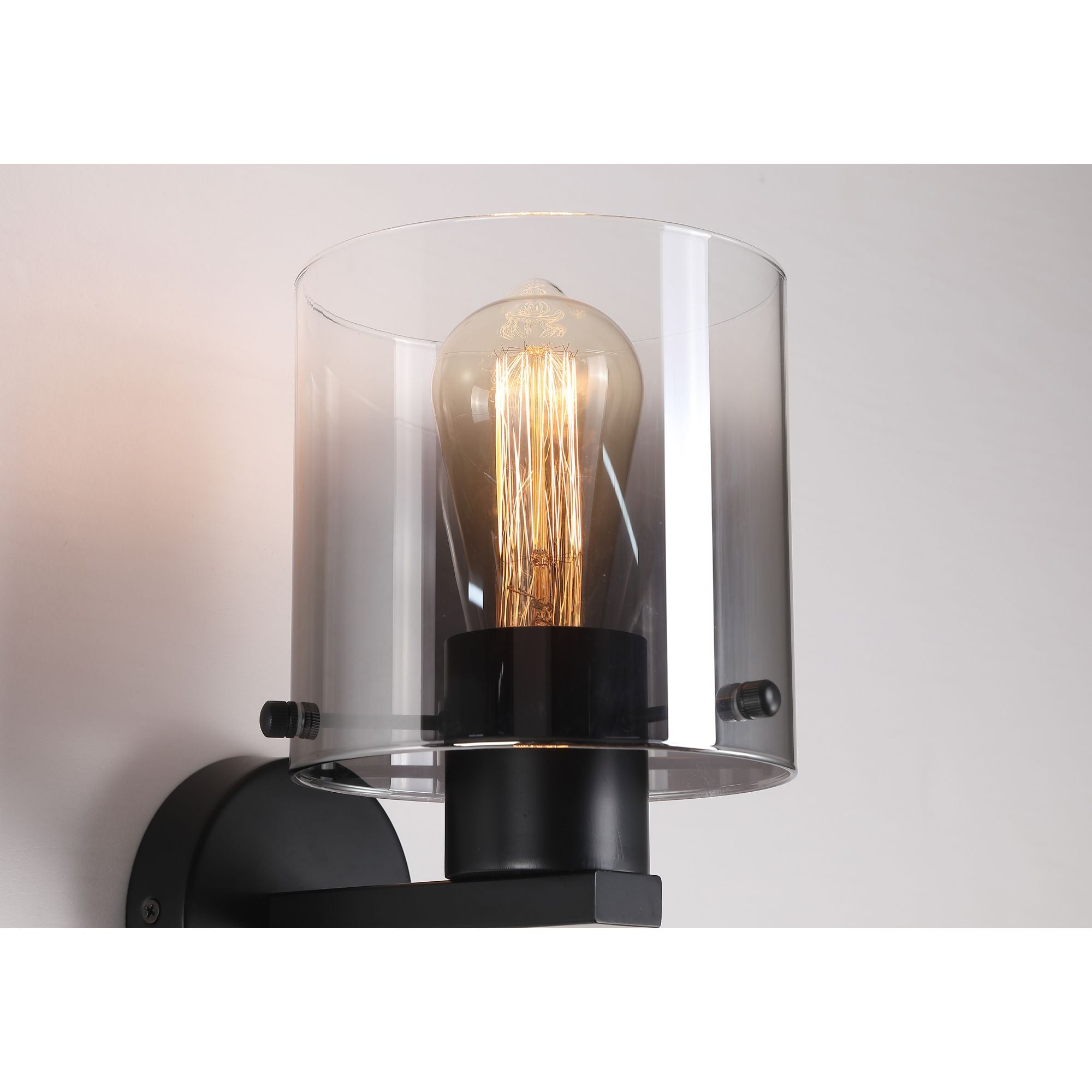 Close up of the smoked glass shade, fixing pins and lit filament bulb on the Searchlight Sweden 1 Light Wall Light