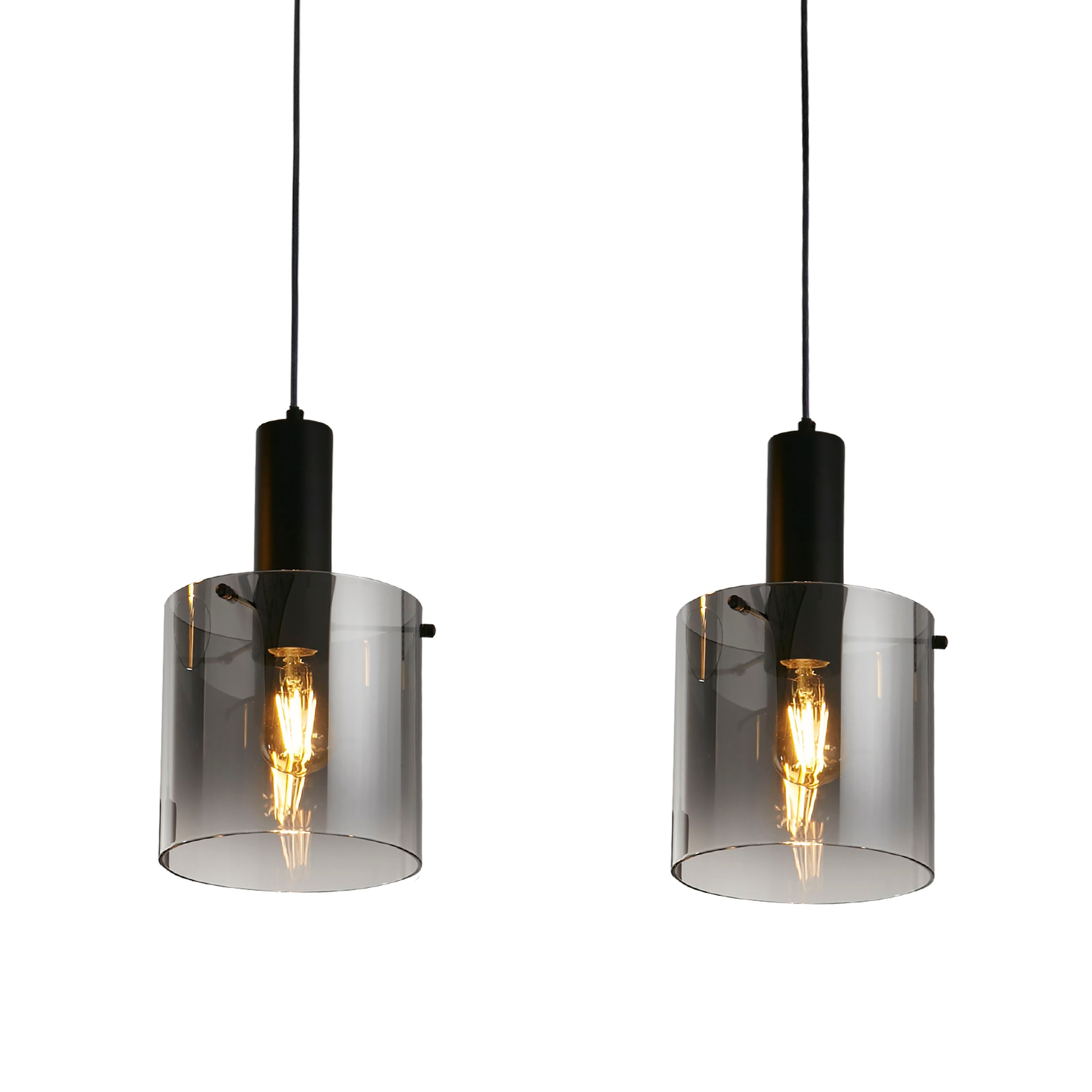 Close up of two Sweden 3 Light Bar Pendant shades in smoked ombre glass, showing the fade from charcoal to clear glass around the lit bulbs