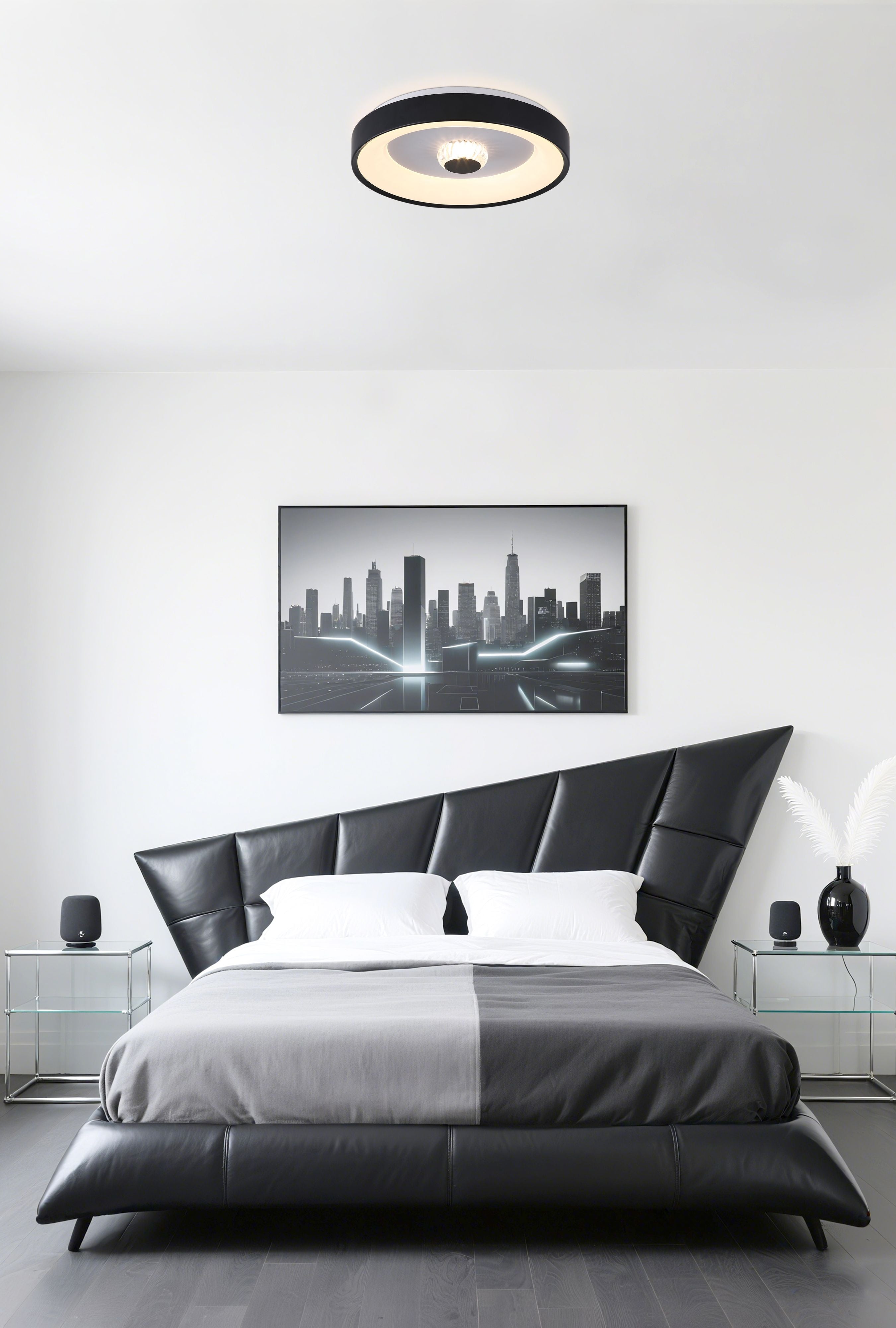 Searchlight Polka LED Flush ceiling light in matt black, styled above a black leather bed with city skyline artwork in a modern bedroom
