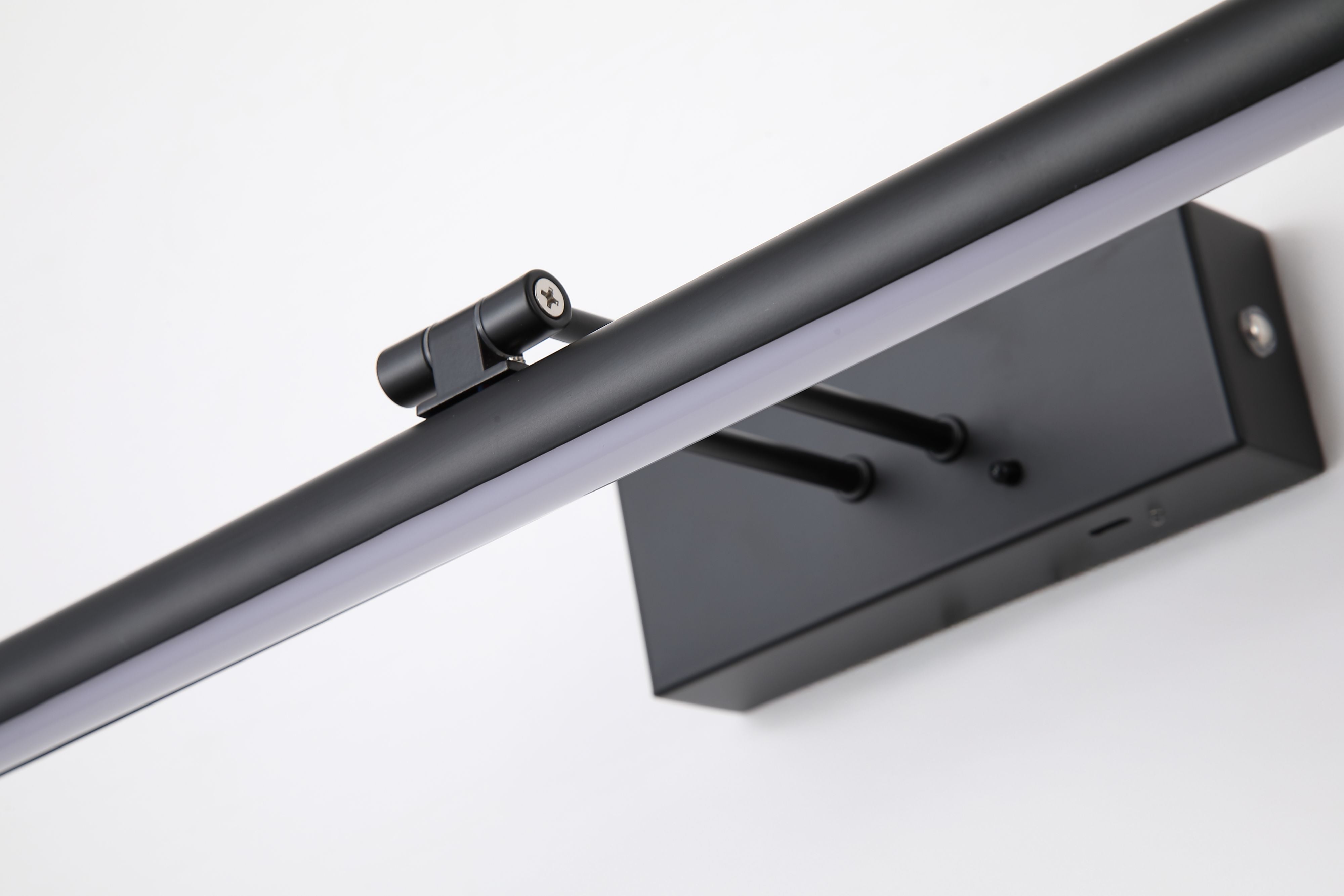 Close up of the Holton wall lamp showing the matt black rectangular housing, mounting pins and acrylic diffuser strip along the bar