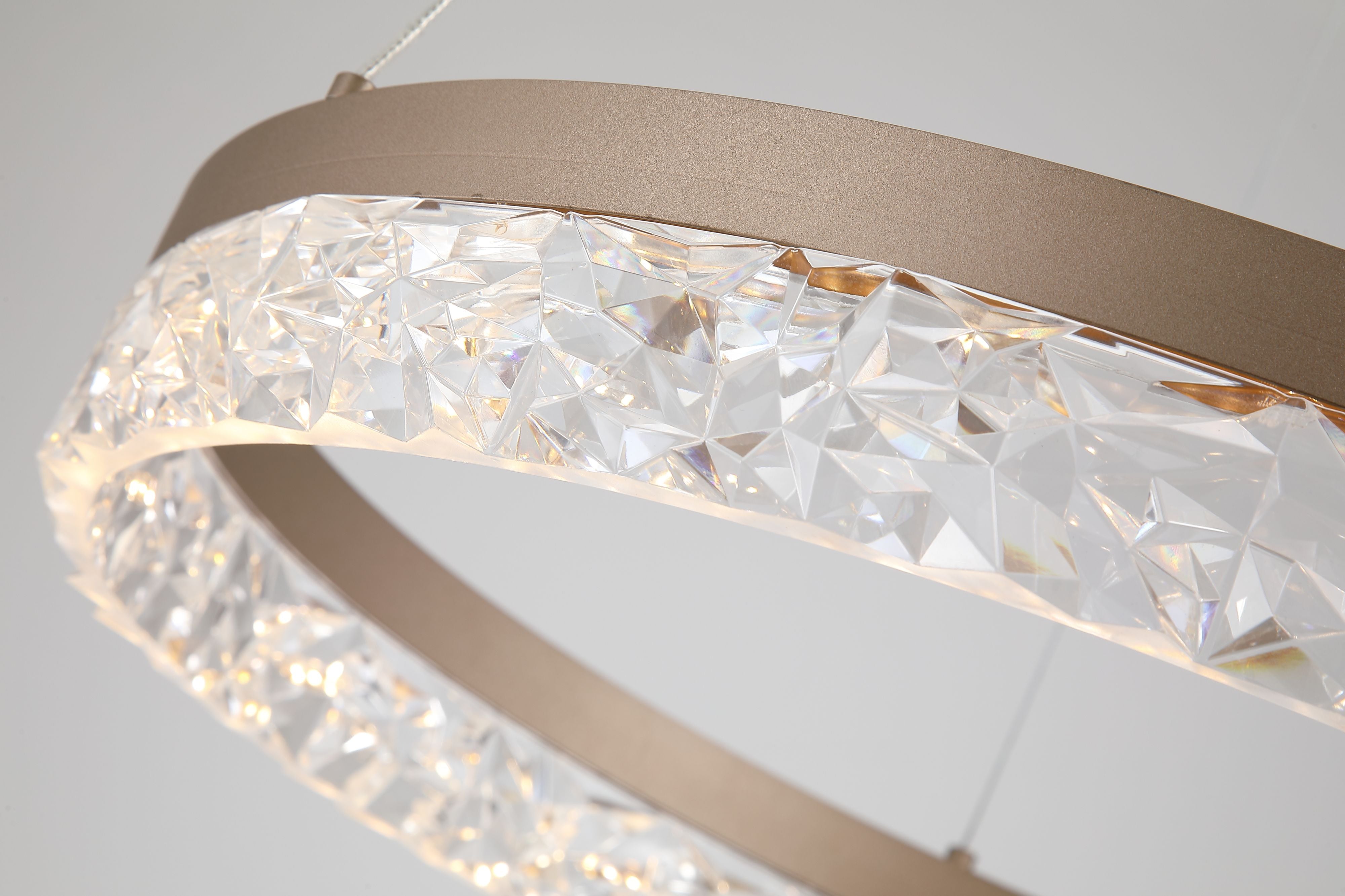 Close up of the Searchlight Maddie pendant's faceted acrylic ring, showing the crystal effect texture and warm LED glow