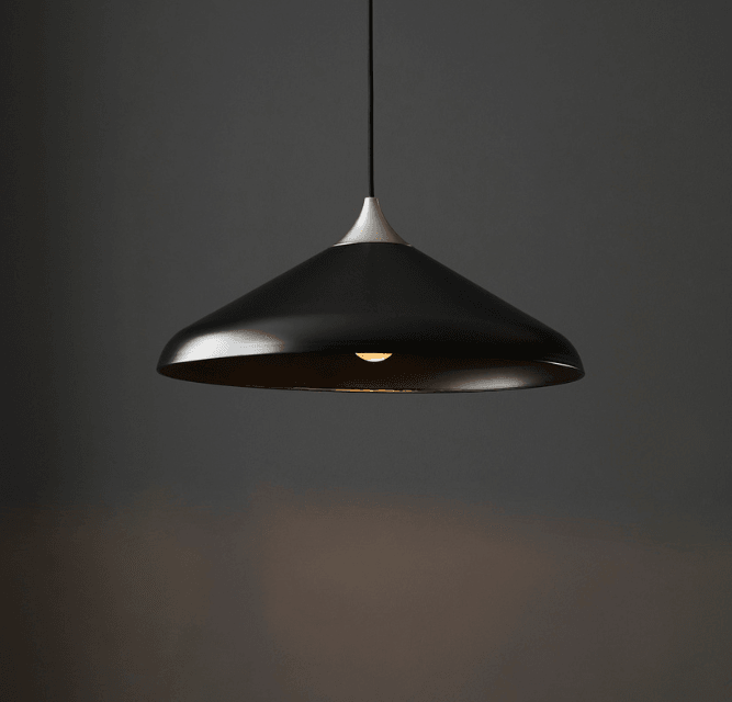 Black pendant light against a dark background