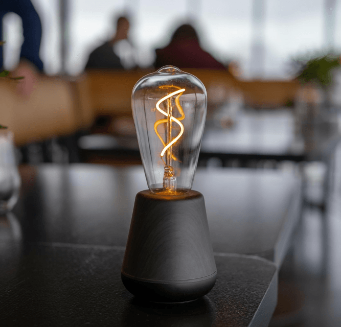Decorative light bulb on a table with blurred background