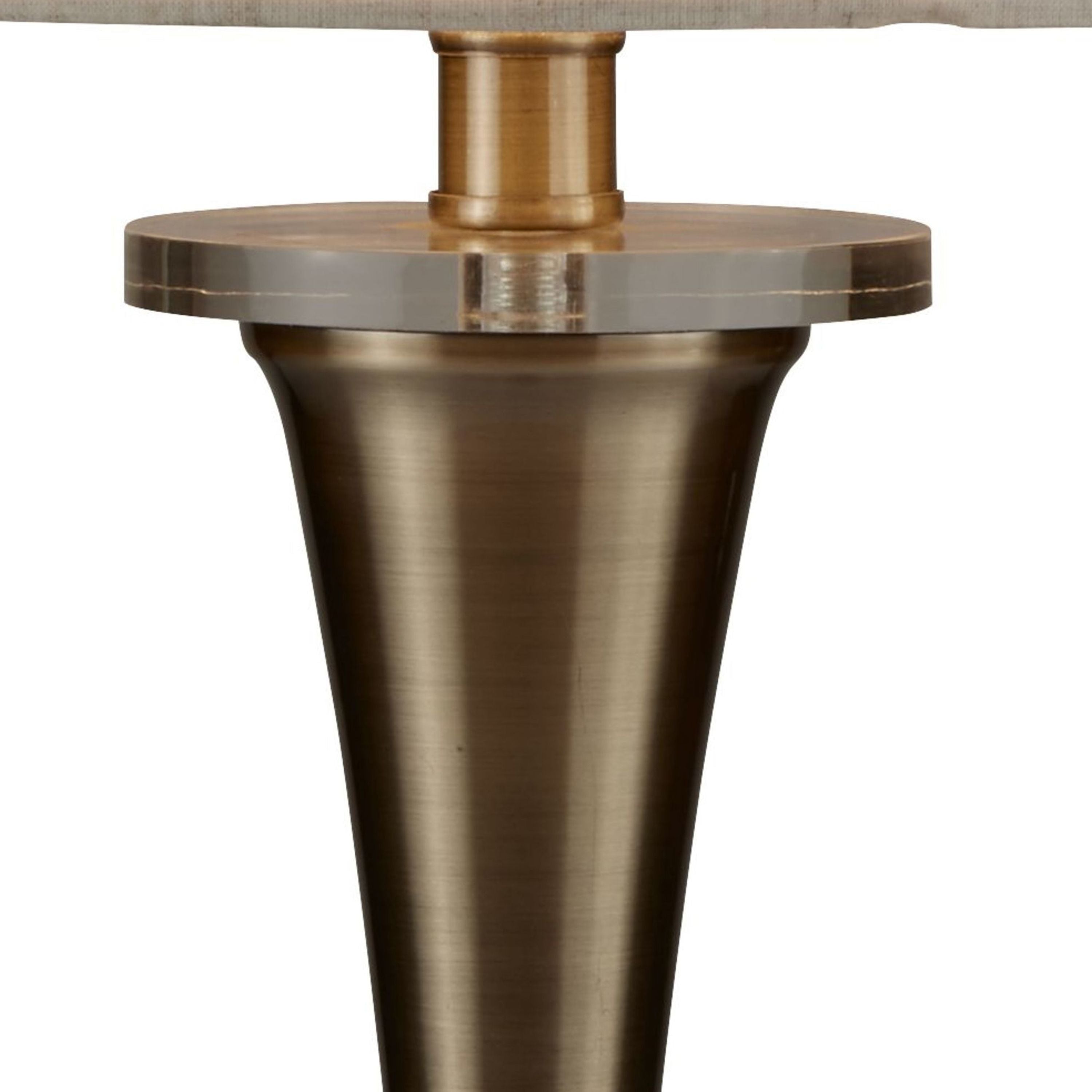 Close up of the Oscar table lamp's antique brass column and clear acrylic ball detail