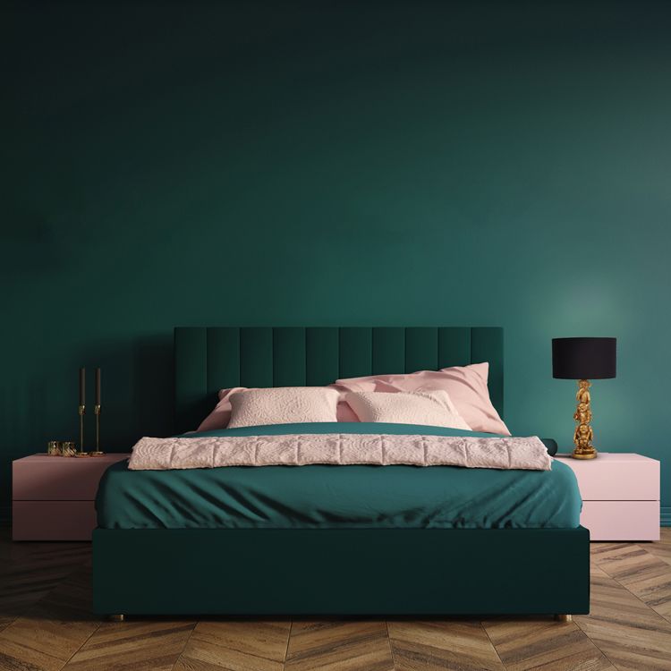 Searchlight 3 Wise Monkeys table lamp with black shade on a pink bedside table beside a dark green upholstered bed with pink bedding