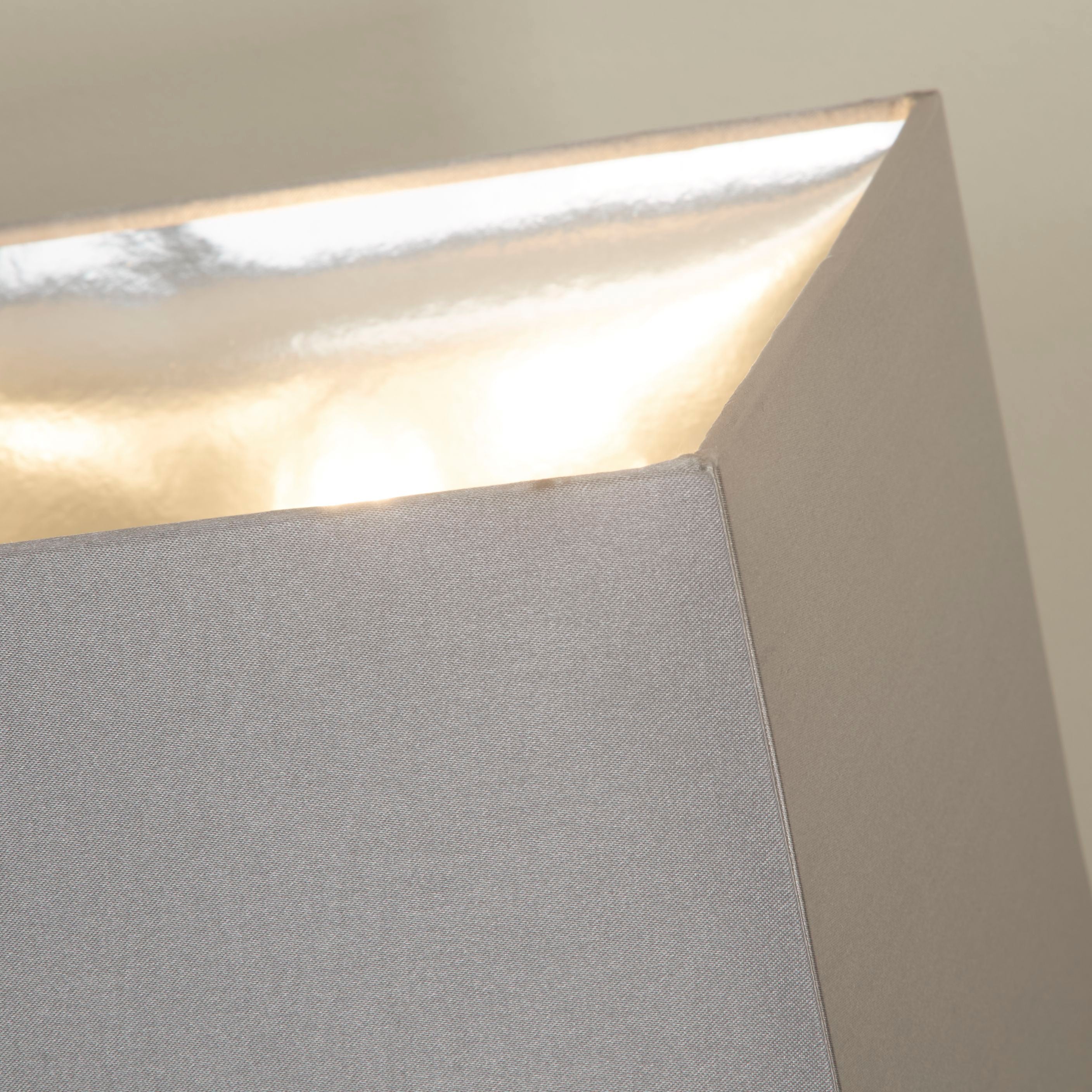 Close up of the grey faux silk shade corner and lining on the Searchlight Megan table lamp
