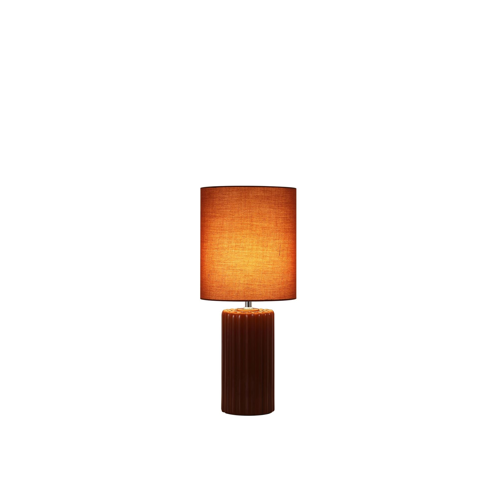 Searchlight Groove table lamp in burnt orange, ribbed ceramic base with matching burnt orange fabric drum shade, studio shot with the lamp lit