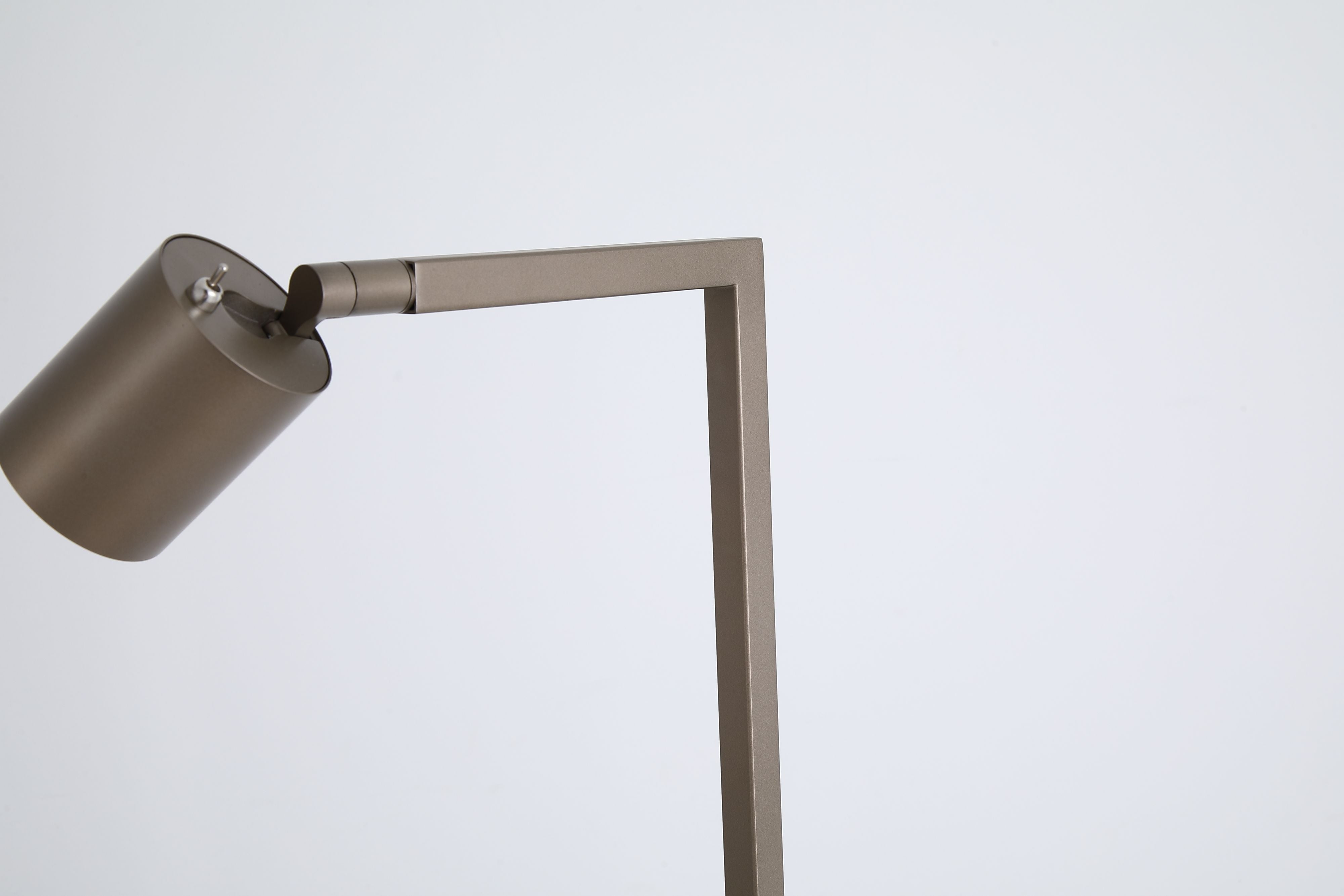 Close up of the Office floor lamp's cylindrical shade and the joint at the top of the frame