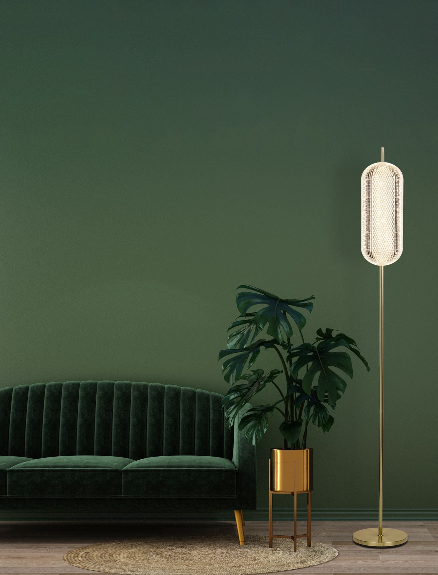 Searchlight Capsule LED floor lamp in satin brass styled beside a dark green velvet sofa and a monstera plant in a brass planter