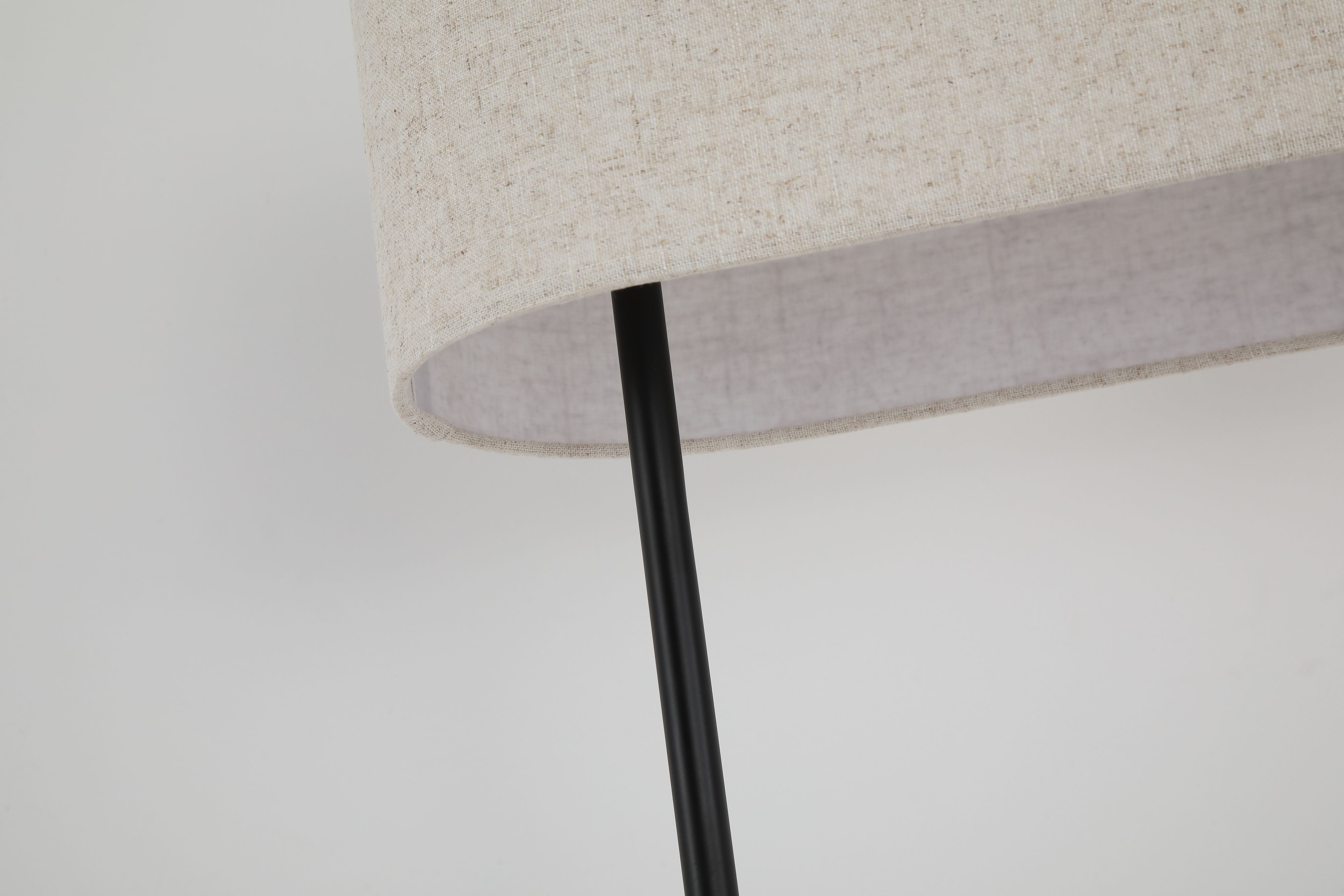Close up of the underside of the Searchlight Hessian floor lamp shade, showing the woven linen texture and the black metal stem passing through it