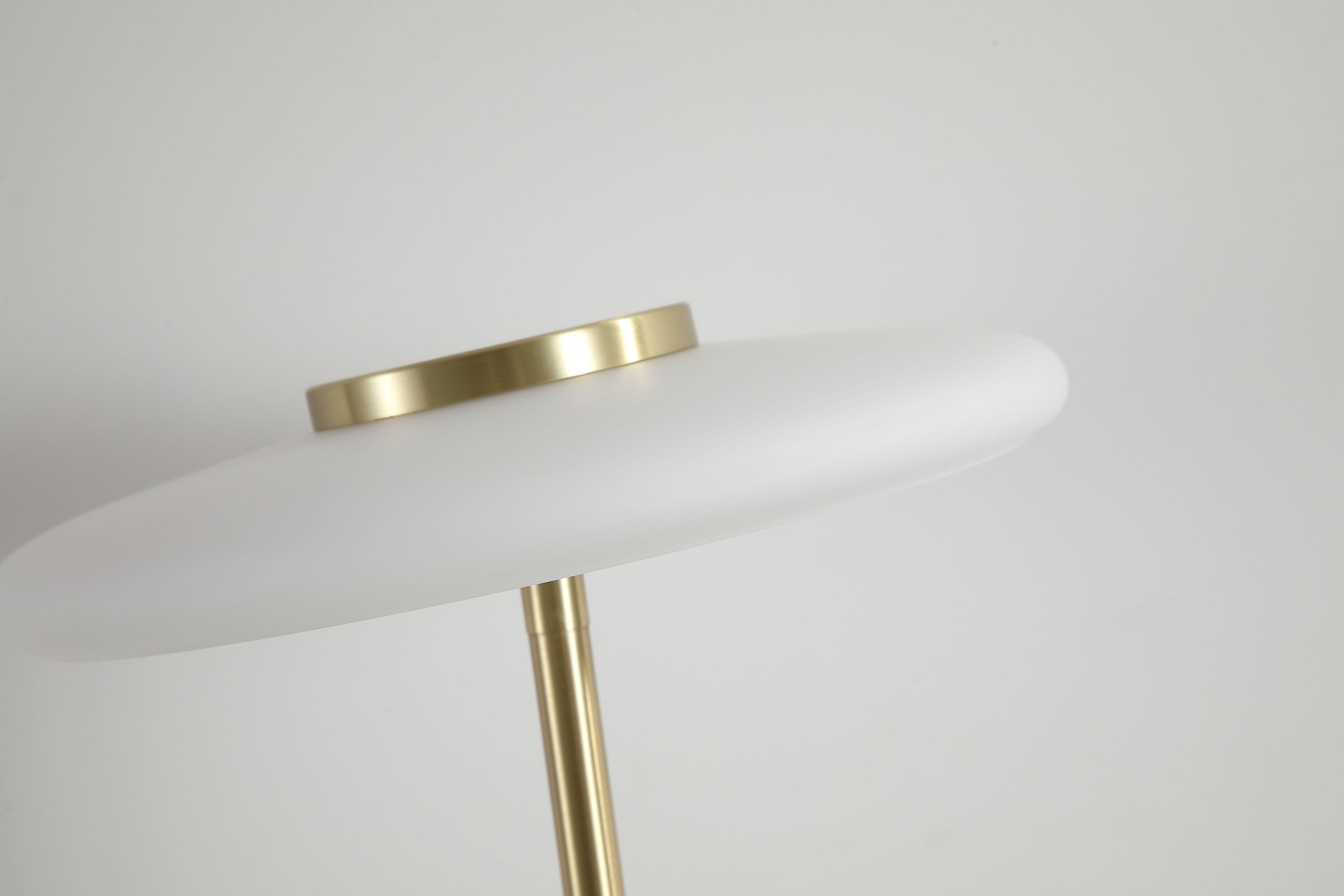 Close up of the Record lamp's white glass shade and the satin brass ring where it meets the stem
