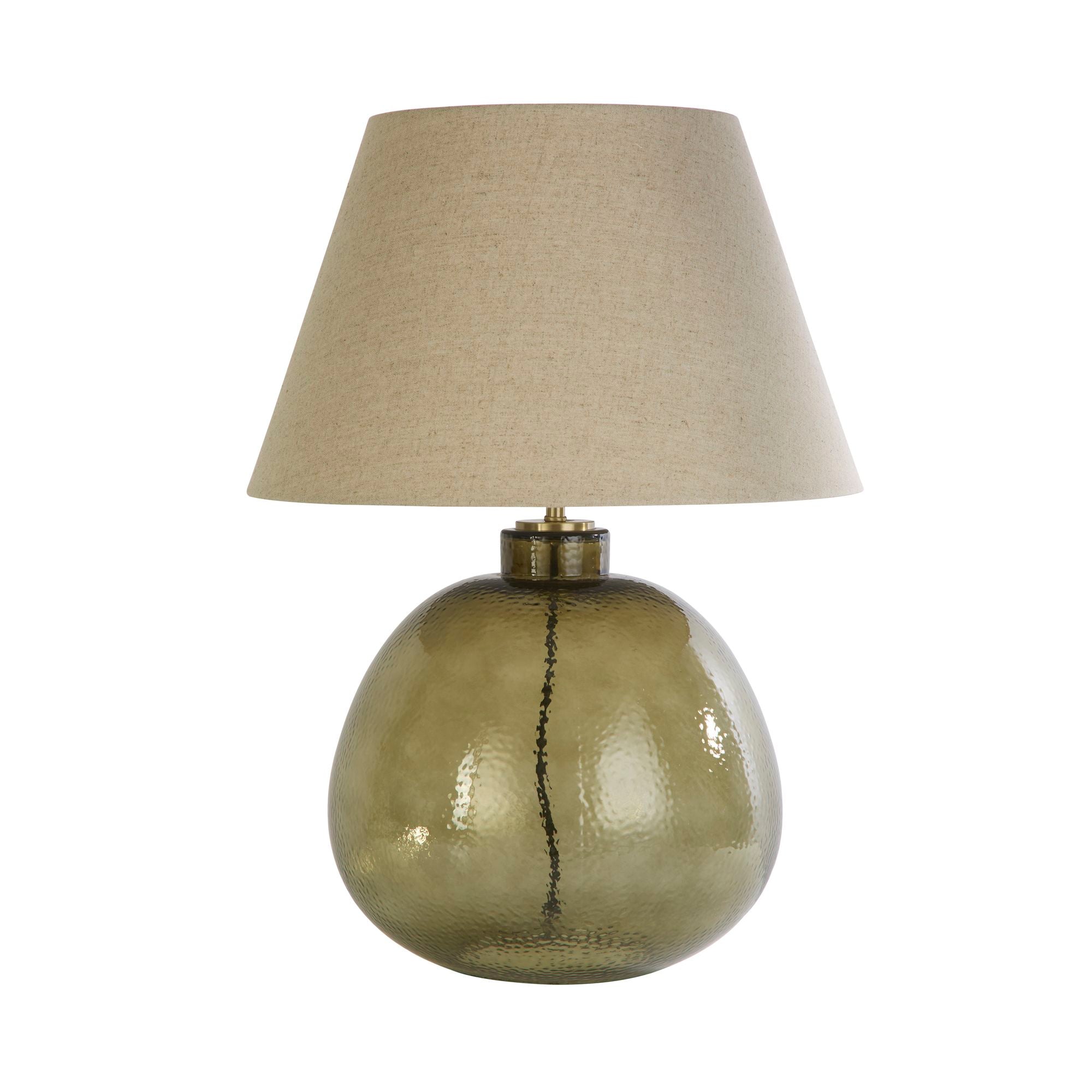 Searchlight Zenith table lamp shown from a slightly different angle, round hammered olive green glass base with a natural linen tapered shade