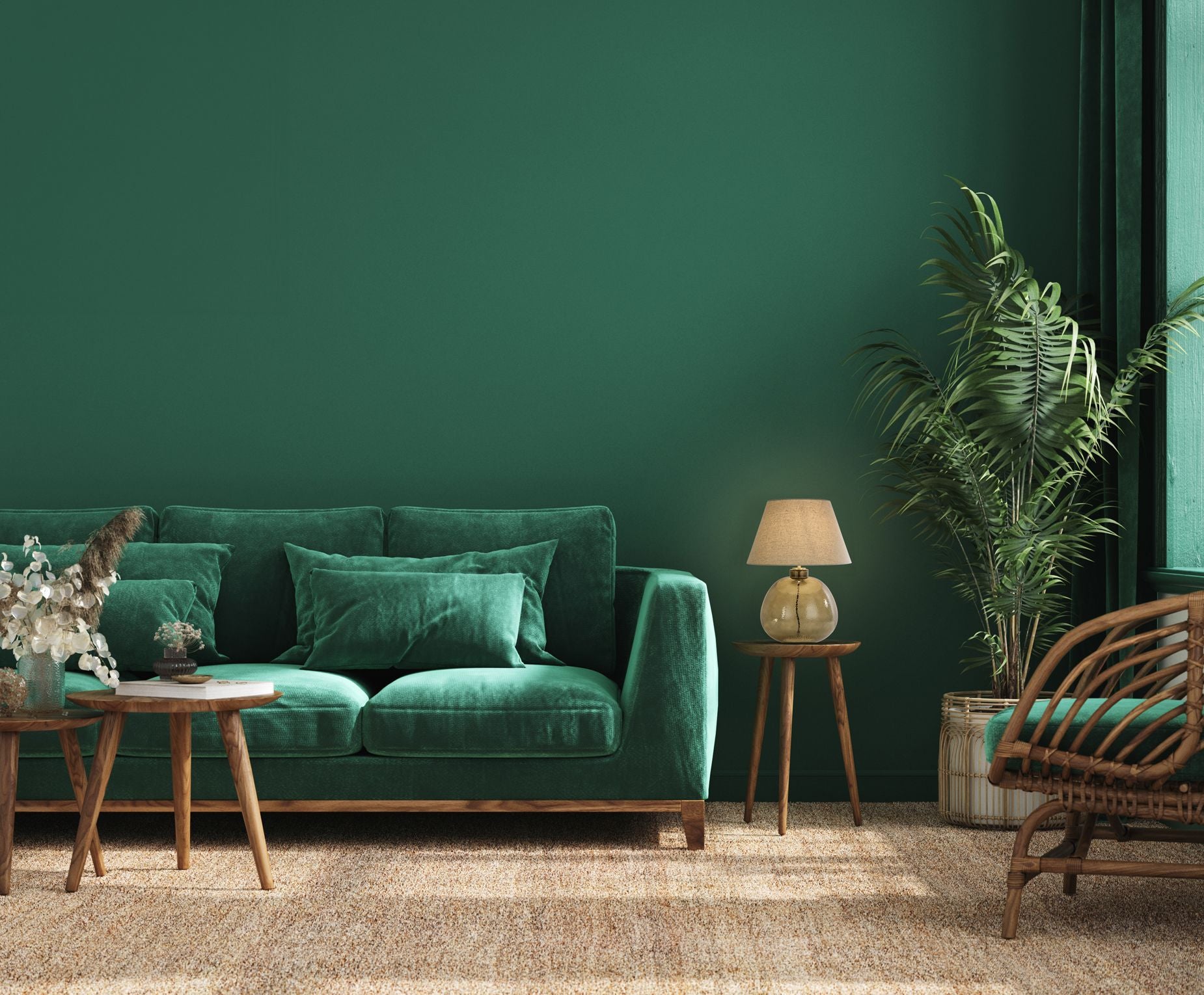 Searchlight Zenith table lamp lit on a wooden side table beside a green velvet sofa, with a rattan chair and potted plant in the background