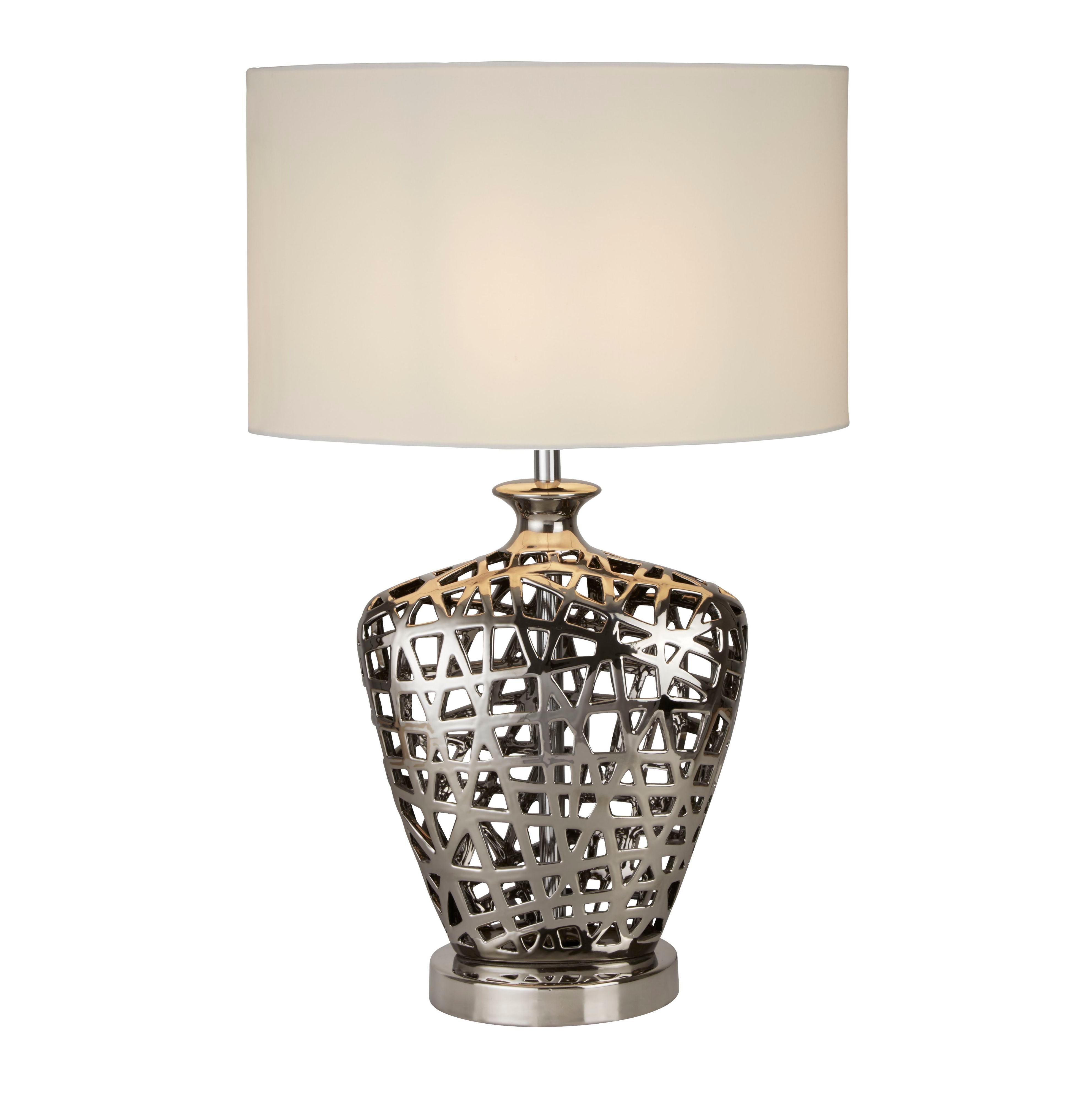 Searchlight large Network table lamp with an openwork chrome effect ceramic base and a white oval fabric shade, studio shot