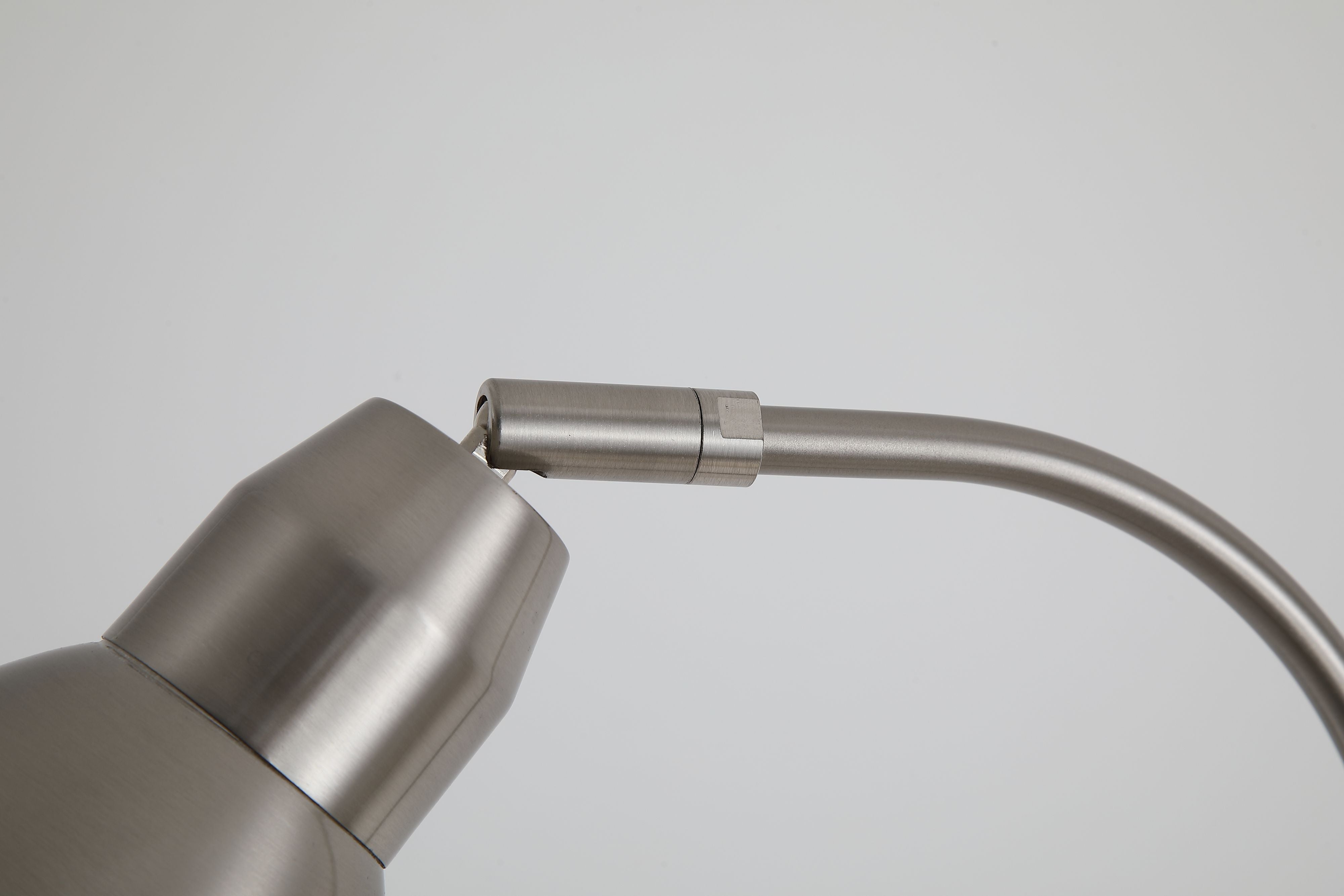 Close up of the Adjustable Floor Lamp neck joint showing the satin nickel finish and hinge detail
