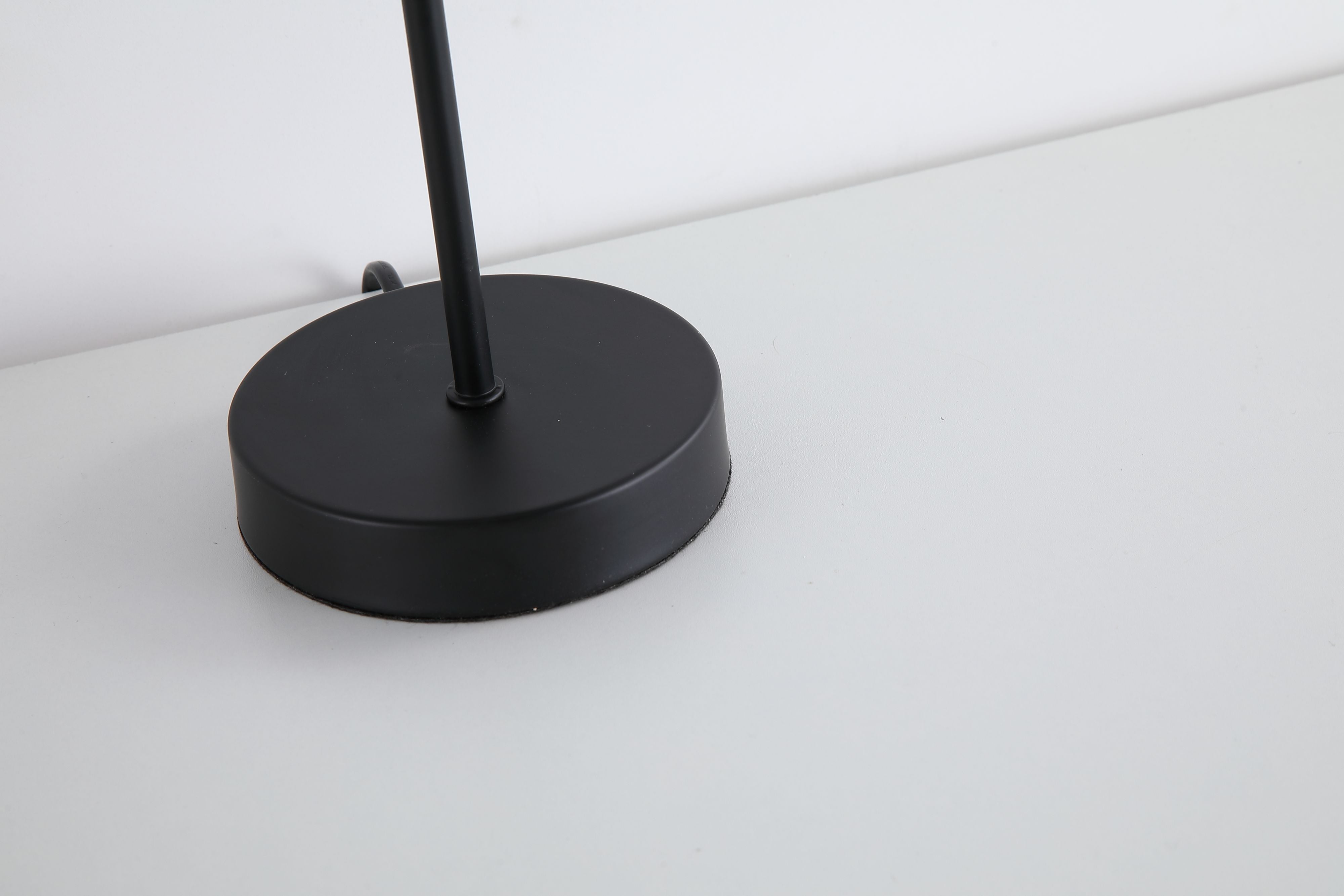 Close up of the Swizzle matt black table lamp base and stem showing the matt black finish