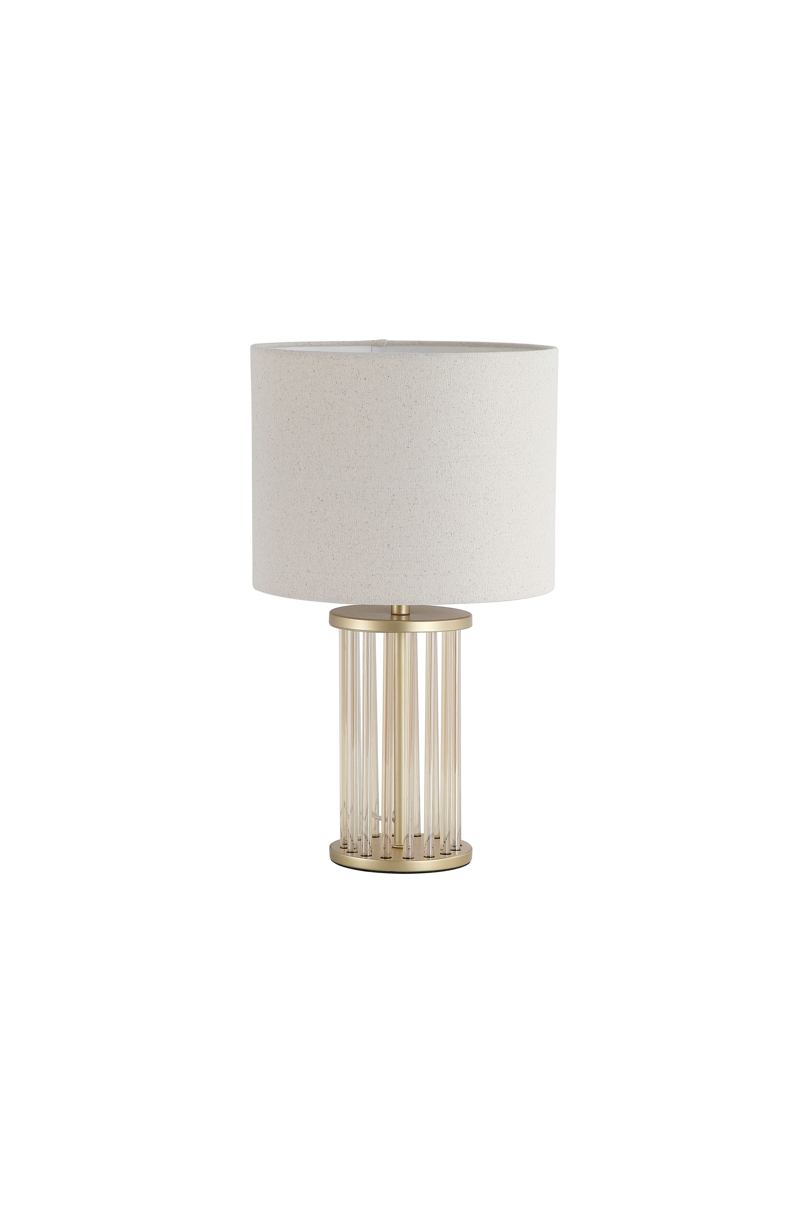 Searchlight Swizzle table lamp in gold with a white linen shade, front on studio shot showing the ribbed glass rod base