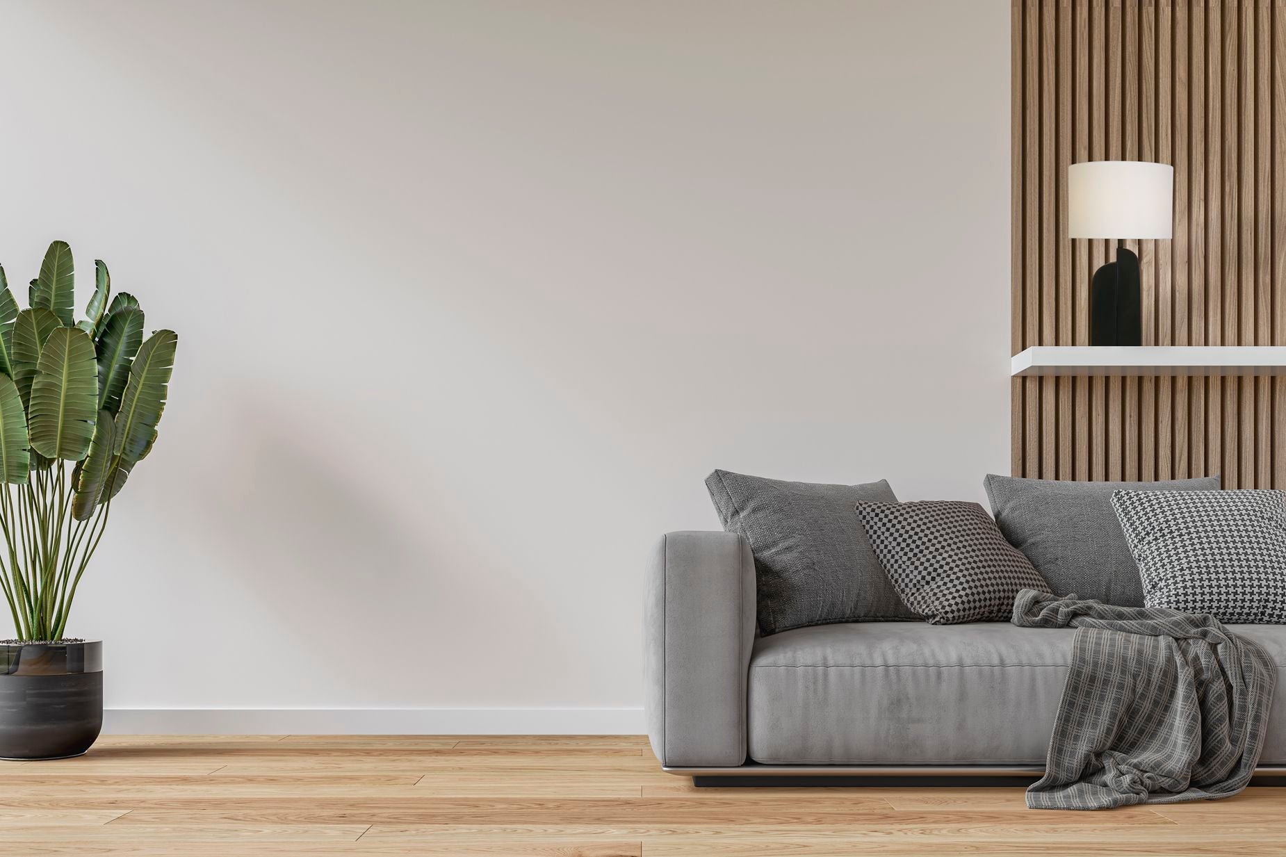 Searchlight Perth table lamp styled on a shelf beside a grey sofa, matt black base and white linen shade lit in a living room setting