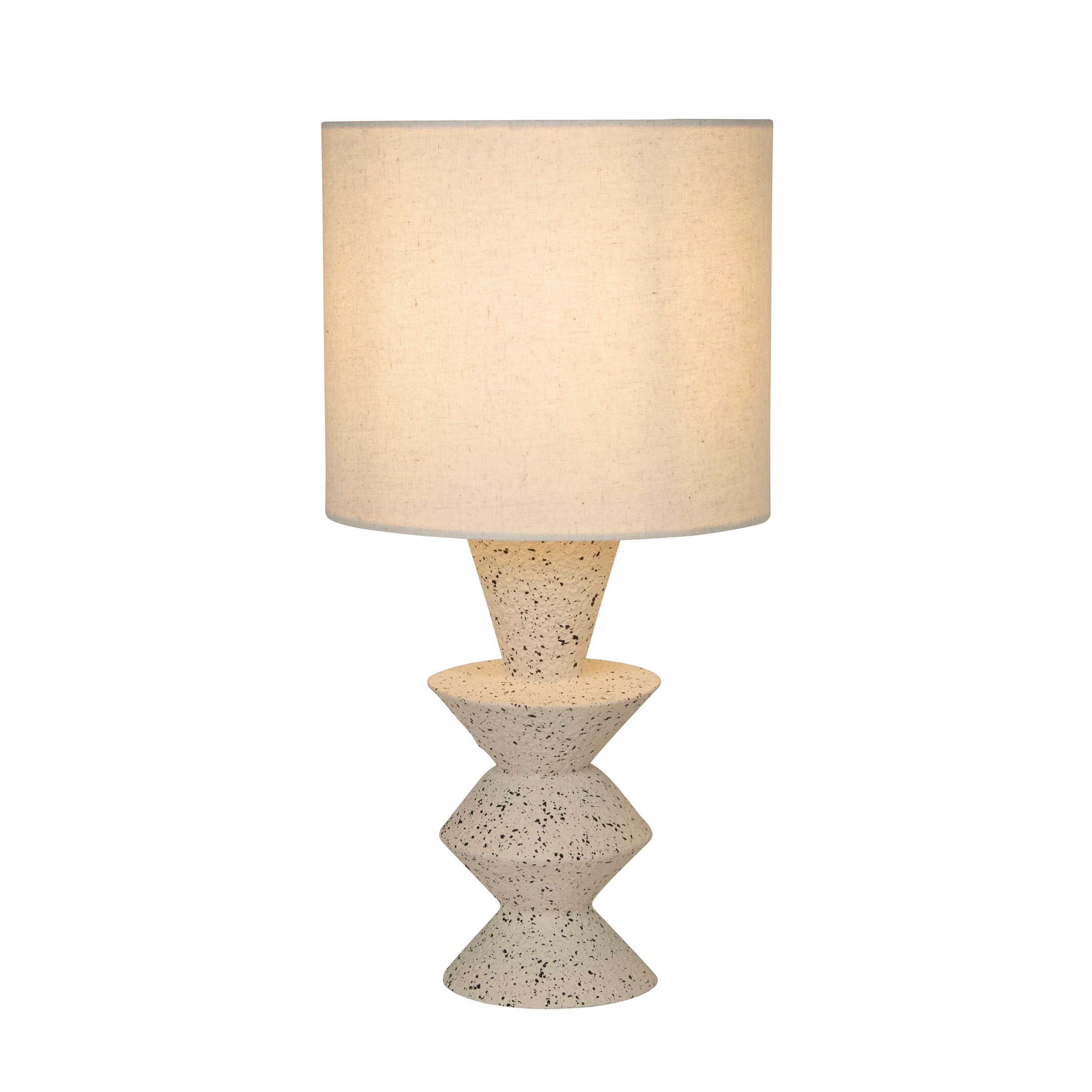 Searchlight Malacca table lamp with speckled stoneware stacked cone base and white fabric drum shade, studio front view