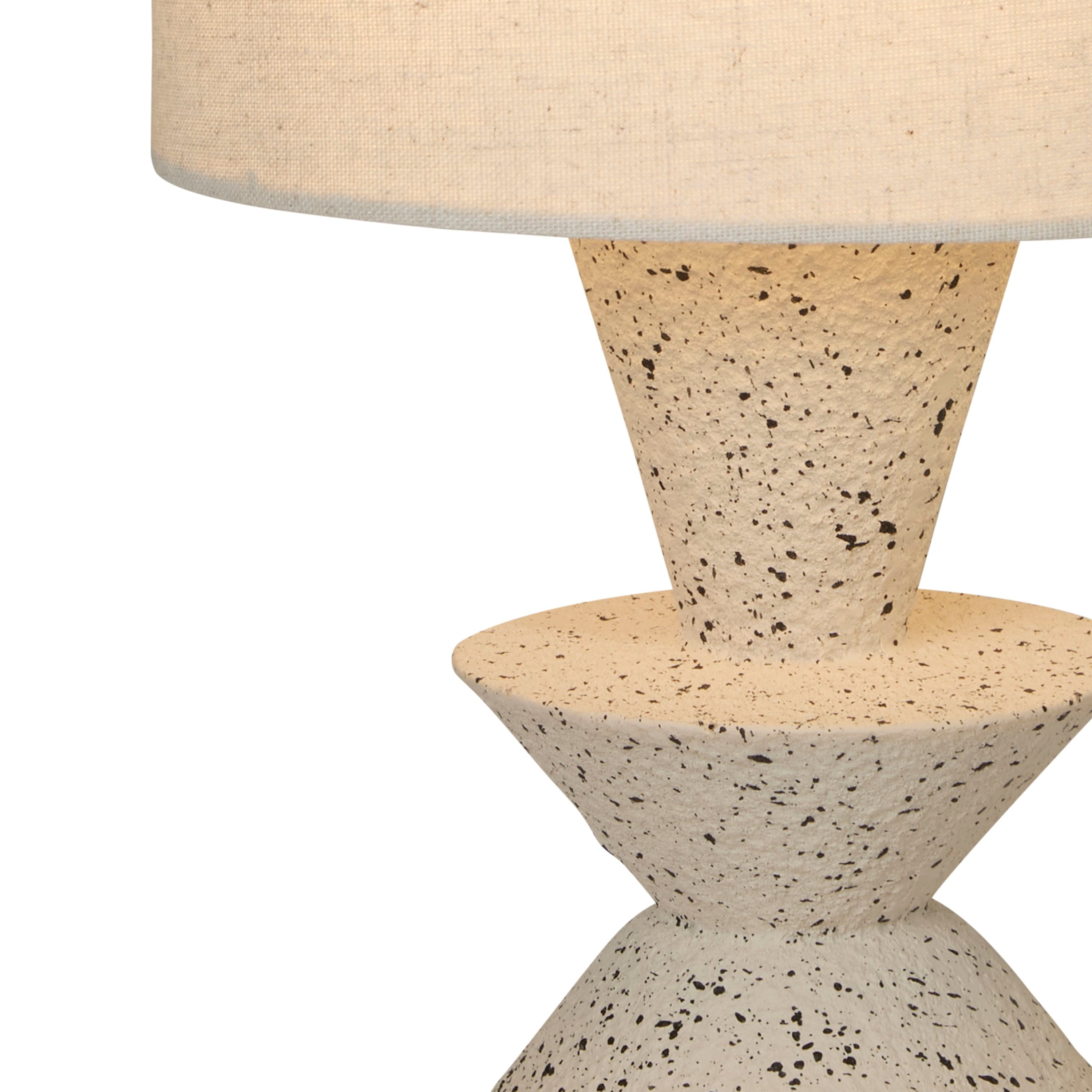 Close up of the Malacca table lamp base showing the speckled stoneware glaze and stacked cone shape
