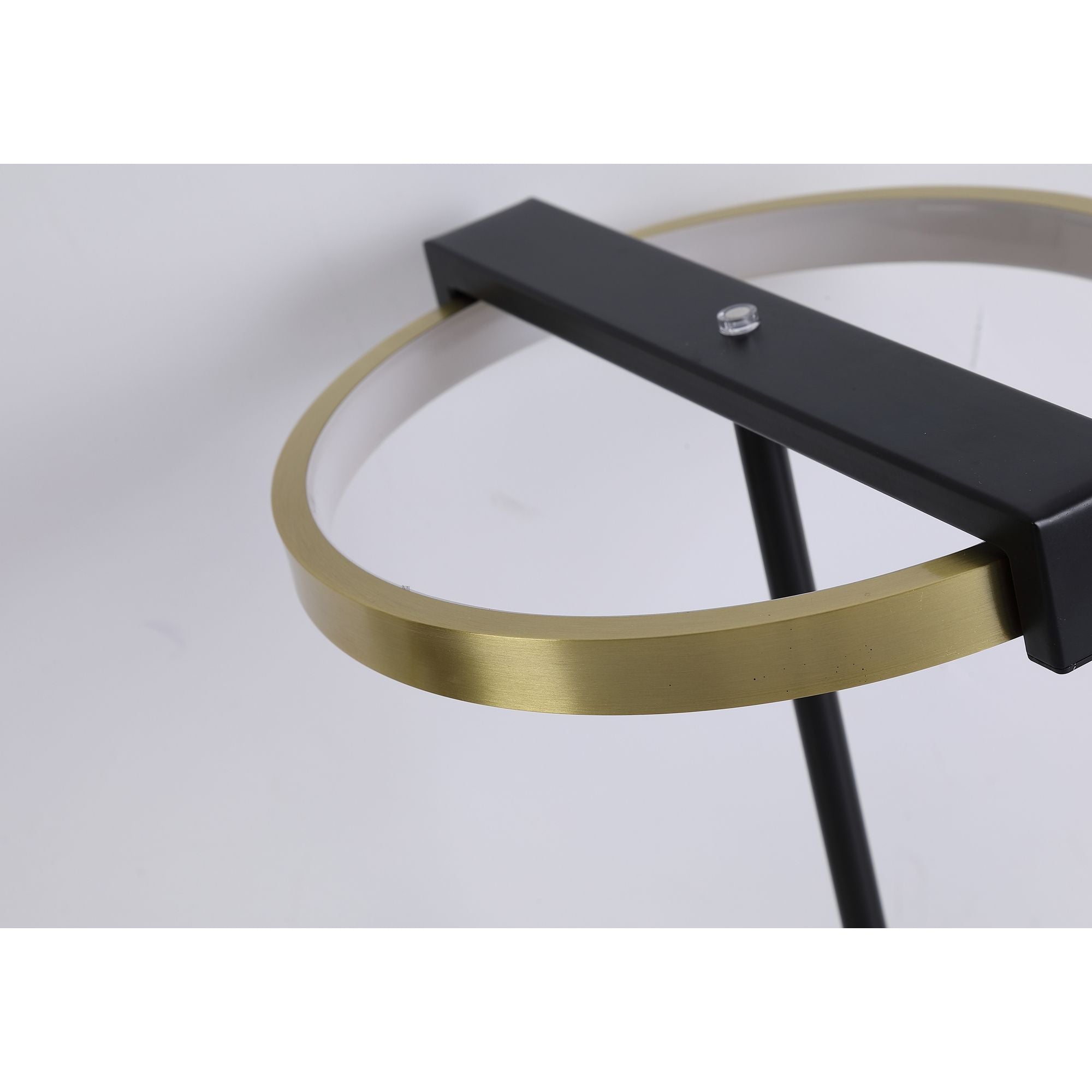Close up of the Searchlight Aerial table lamp ring, showing the brushed gold band and black crossbar with its centre screw fixing