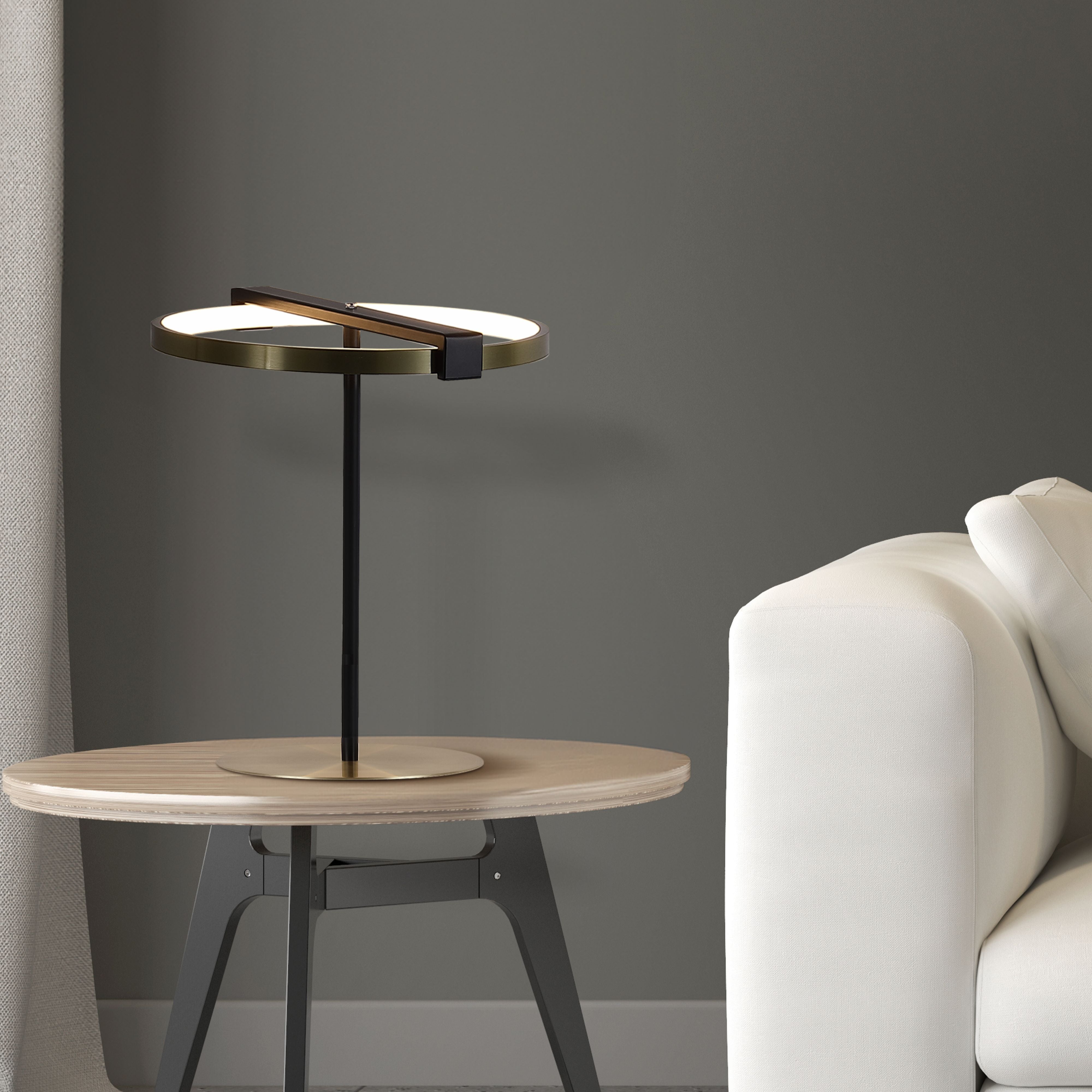 Searchlight Aerial LED Table Lamp styled on a wooden side table next to a cream sofa, ring lit warm white