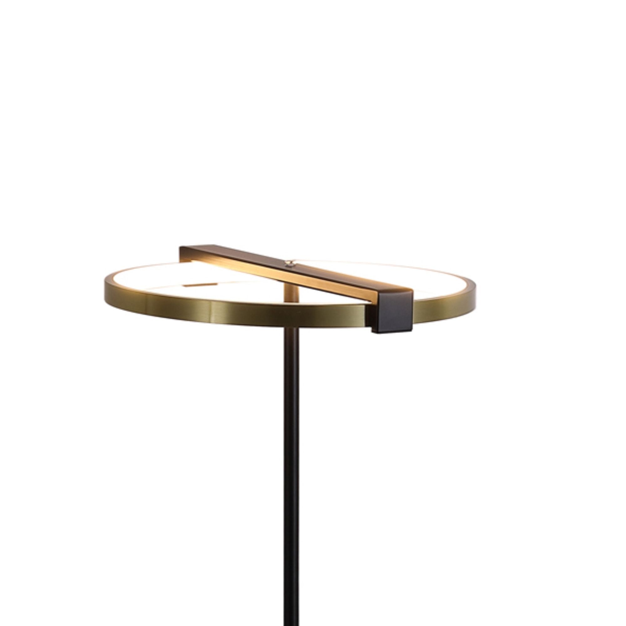 Close up of the Searchlight Aerial floor lamp ring, showing the brushed gold band and black crossbar lit warm white