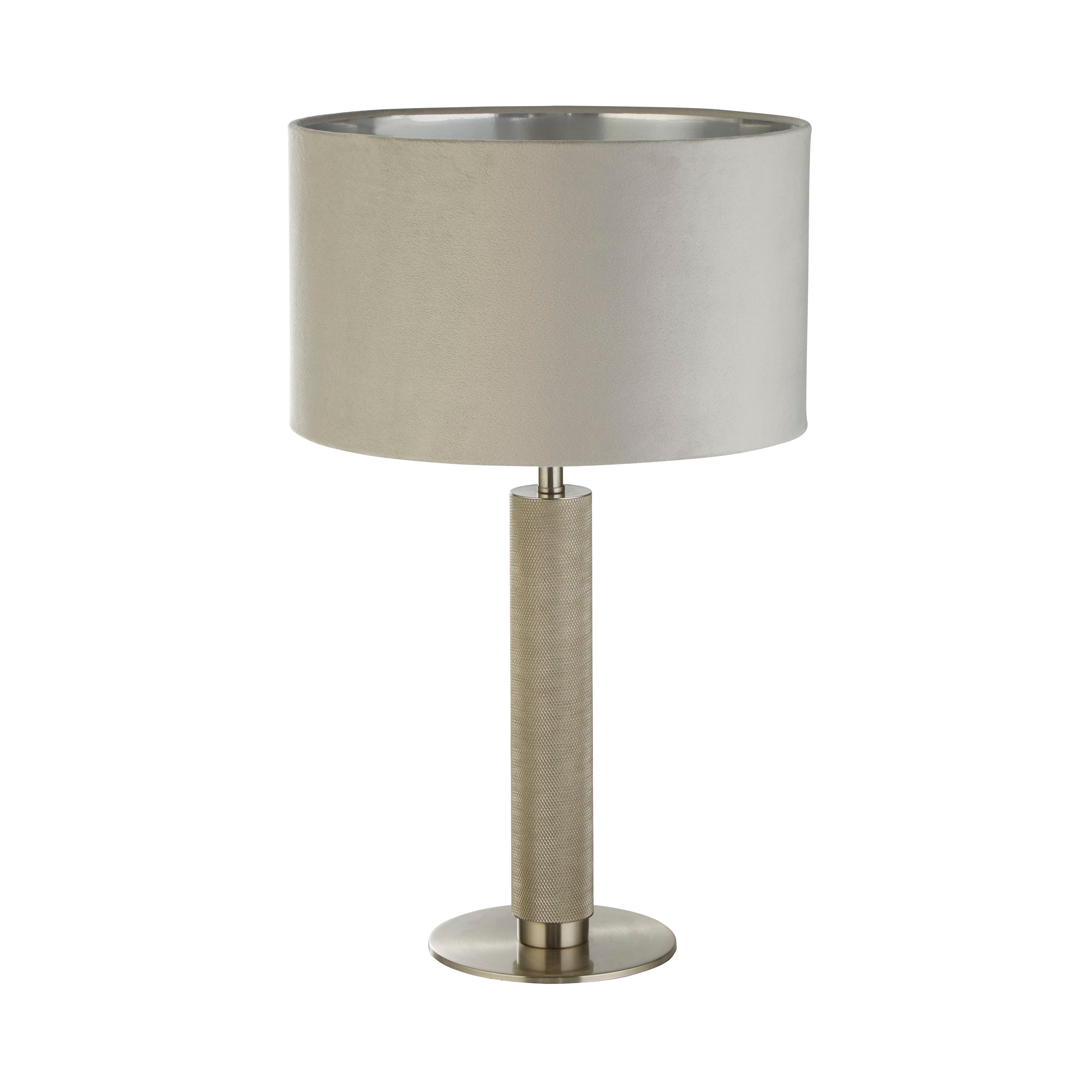 Front view of the London table lamp showing the grey velvet drum shade with its reflective interior and the knurled metal column on a round base, on a white studio background
