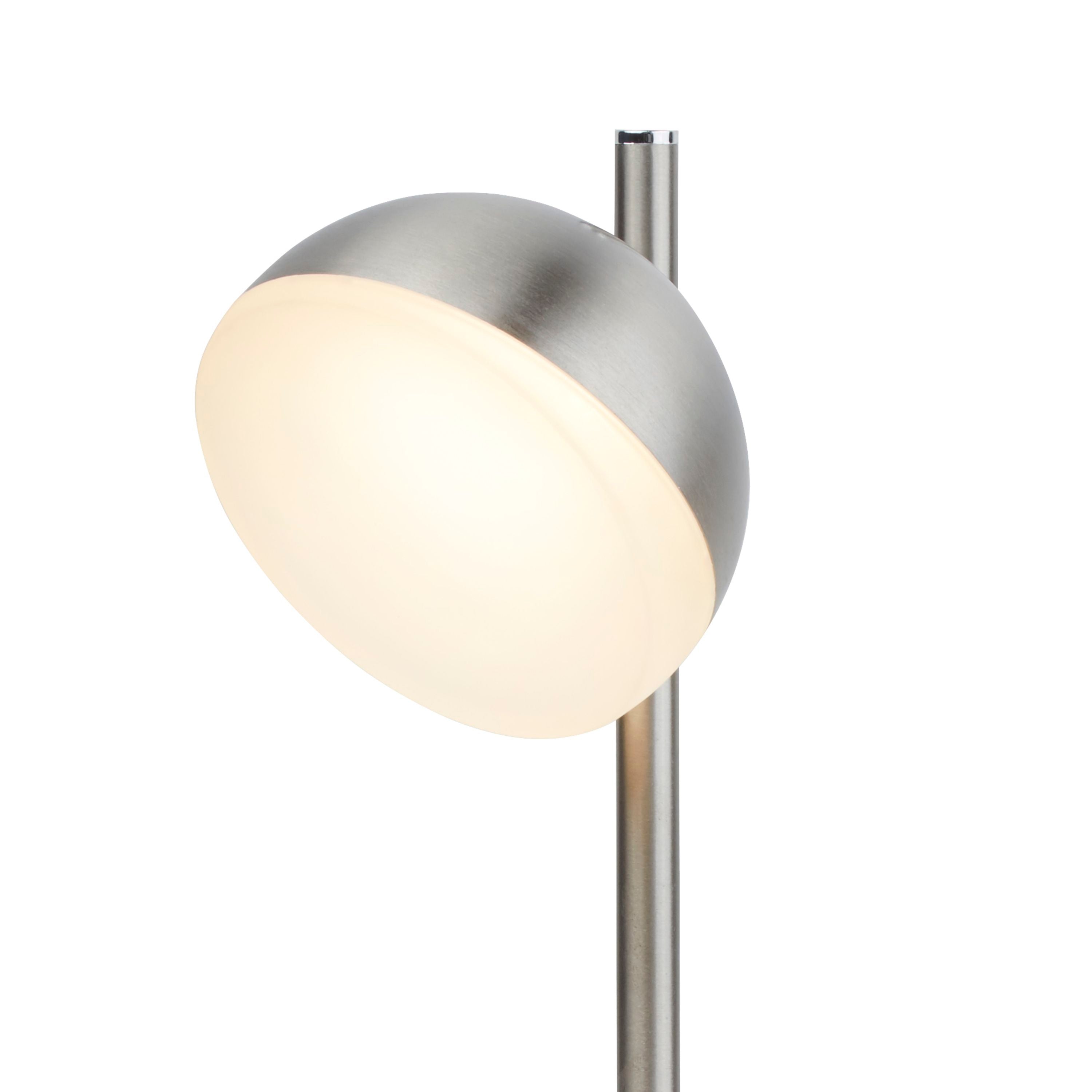 Close up of the Tully table lamp's dome head, showing the satin silver metal edge and frosted glow