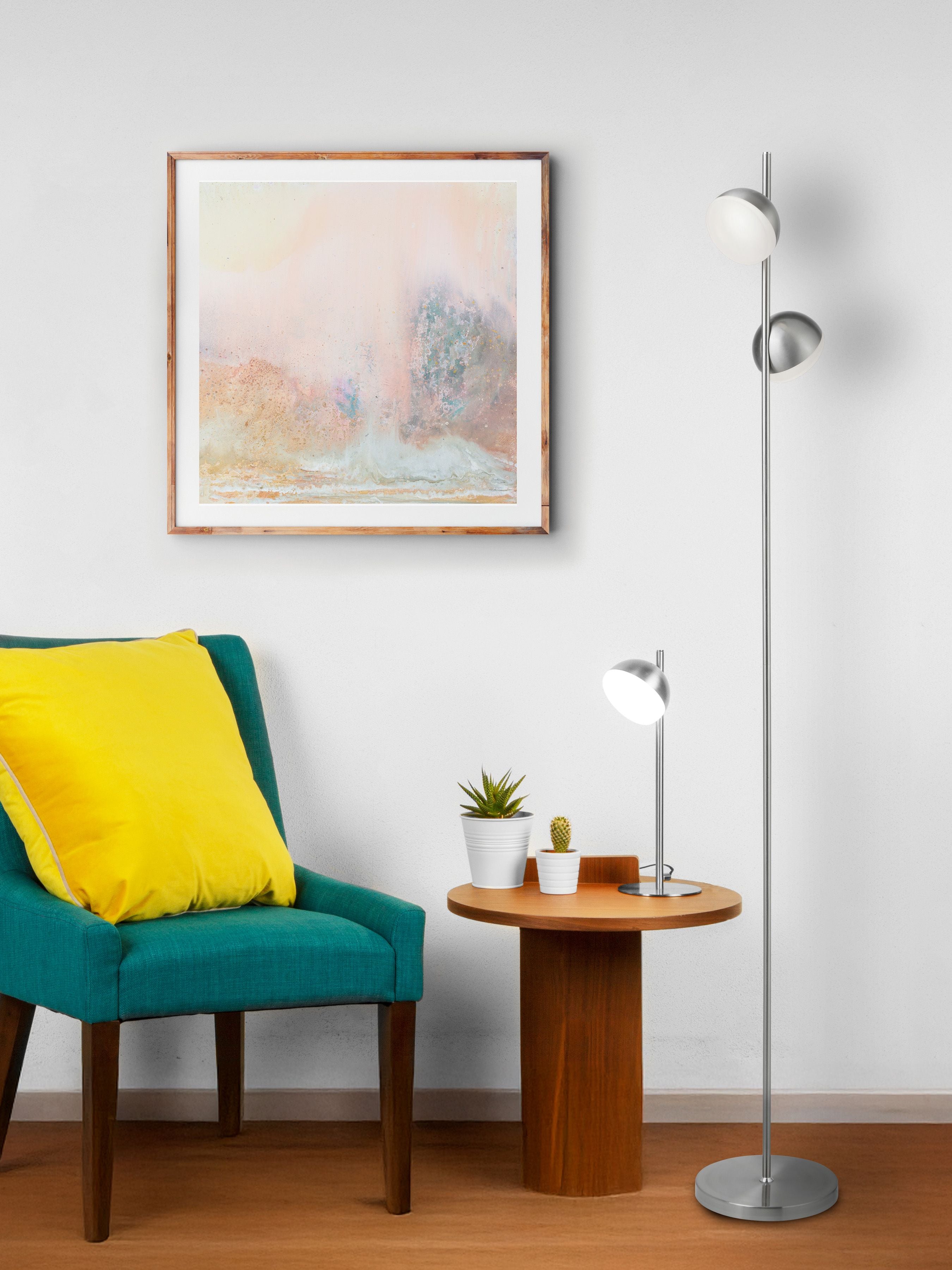 Tully floor lamp in satin silver styled beside a teal armchair and round side table