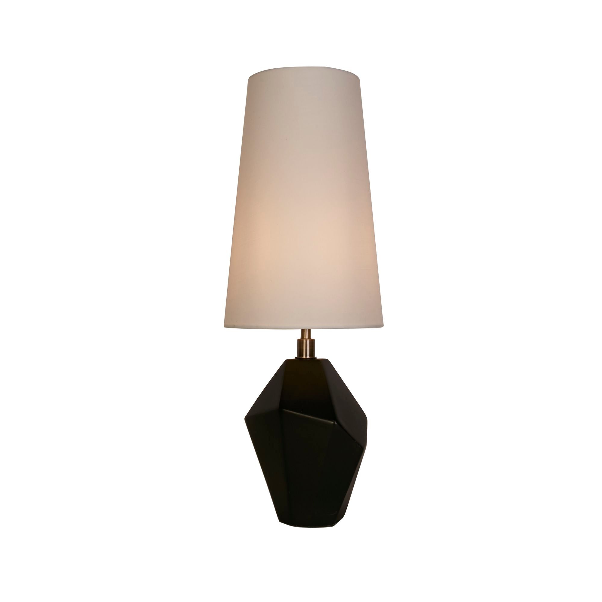 Searchlight Apex table lamp with faceted black resin base, antique brass neck and white tapered shade, studio front view