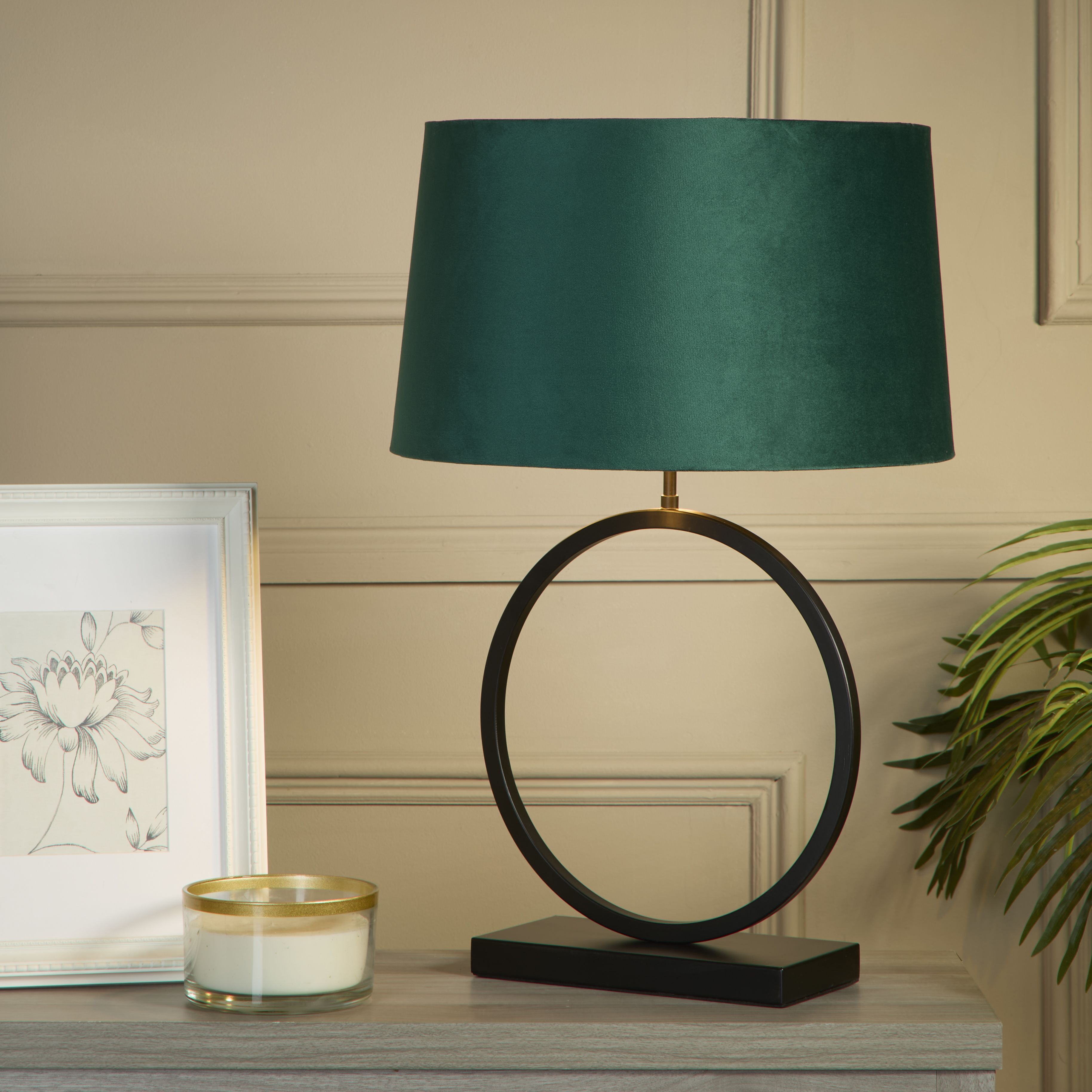 Elegant Table Lamp with emerald velvet shade styled on a console table next to a framed print, candle and a leafy plant