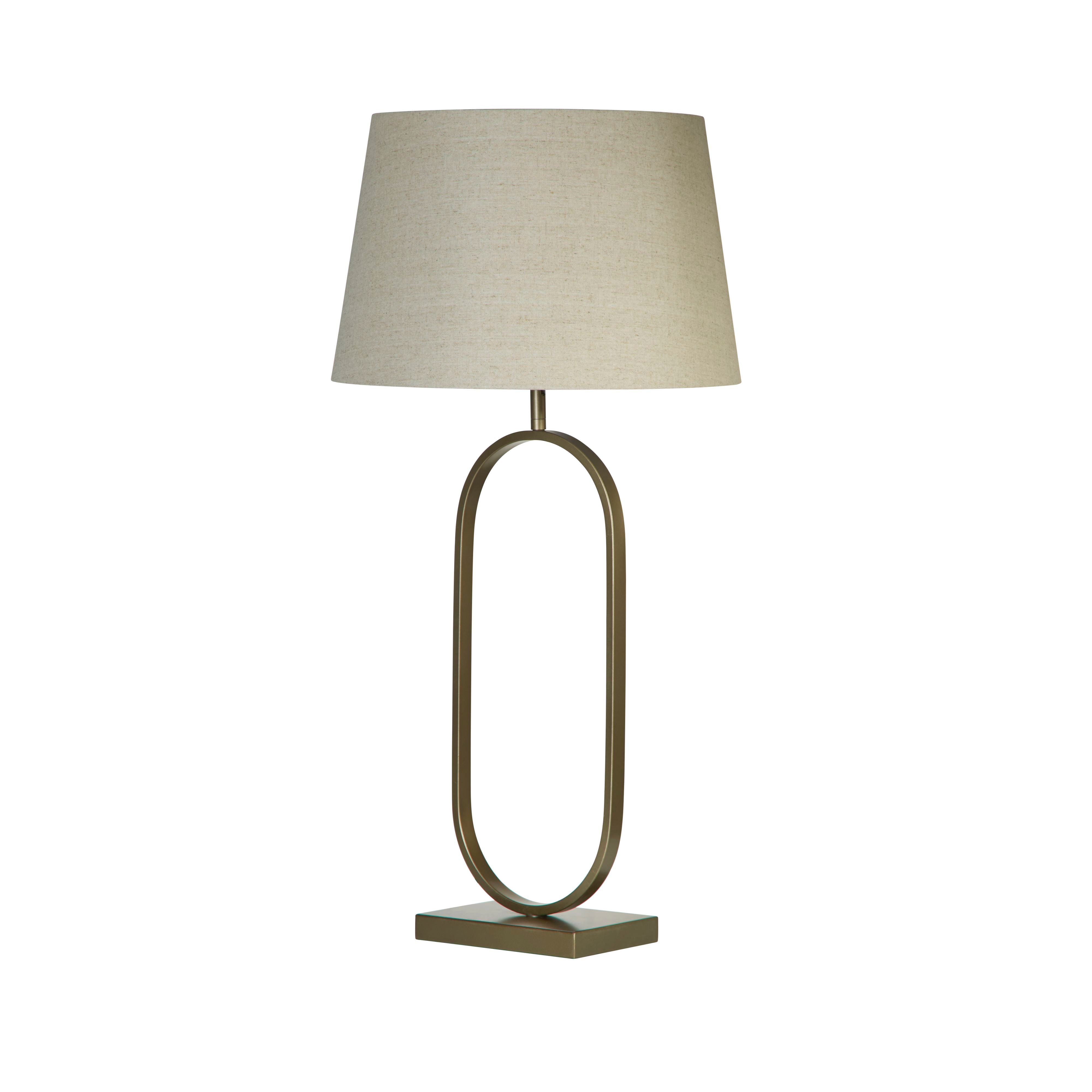 Front view of the bronze oval ring based table lamp with its natural linen shade, on a plain white studio background