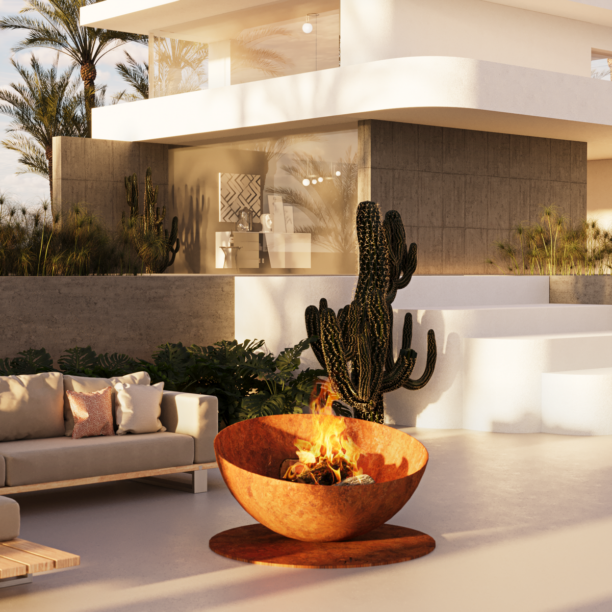 GlammFire Solace rusted steel fire pit with glowing flames in a luxury covered outdoor living and seating area
