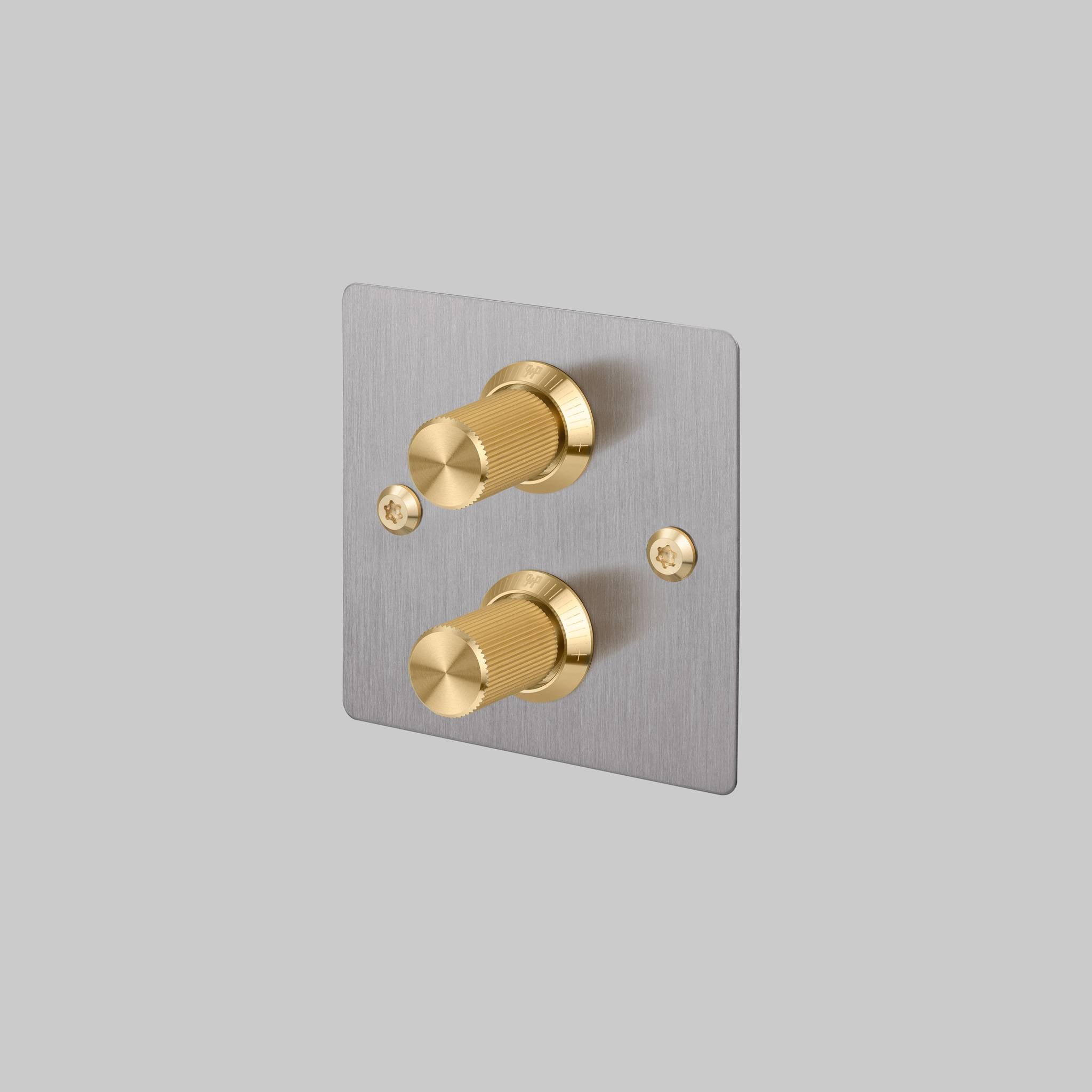 Buster + Punch 2G dimmer switch, steel plate with brass linear knurl knobs, front view