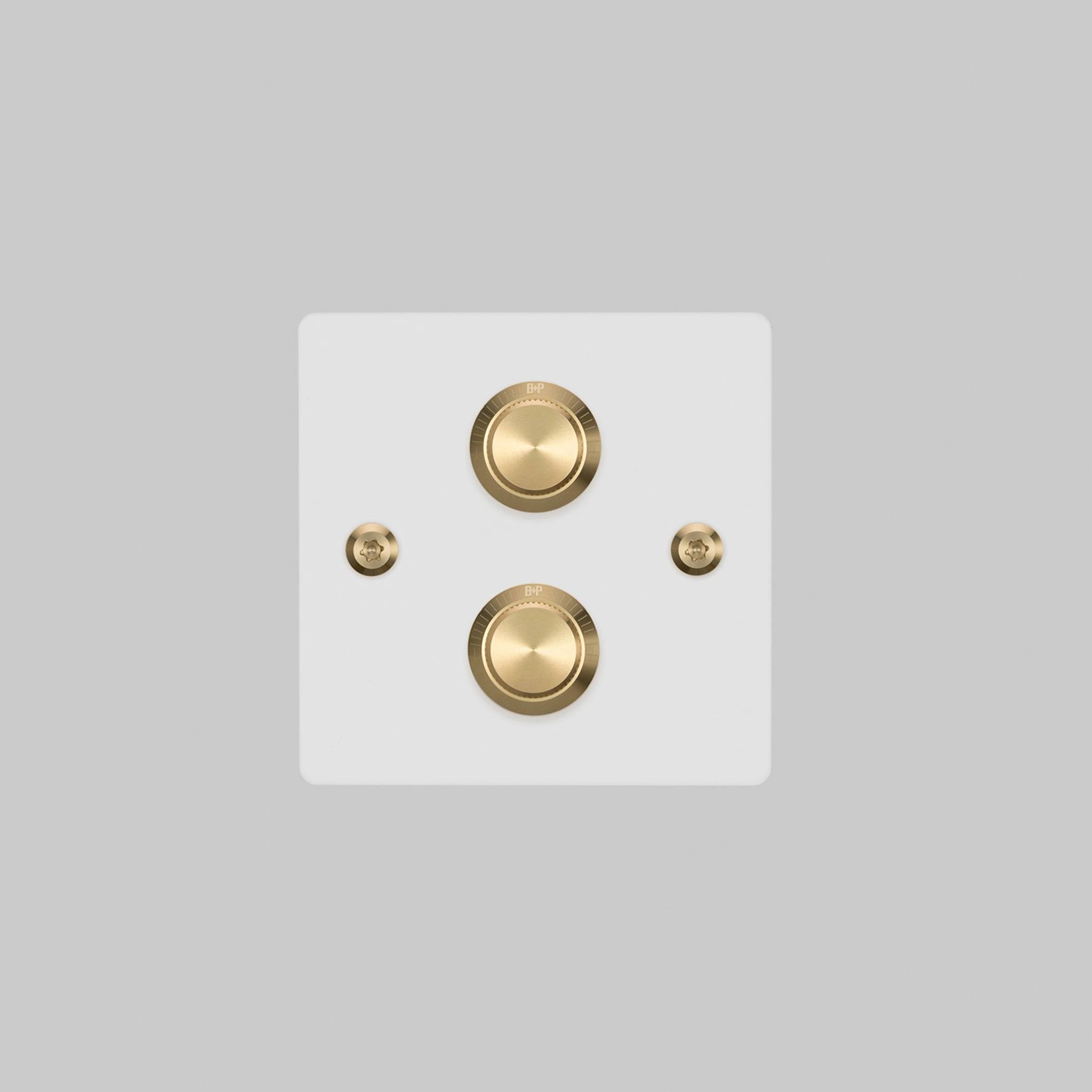 Buster + Punch 2G dimmer switch, white plate with brass linear knurl knob, elevated angle view